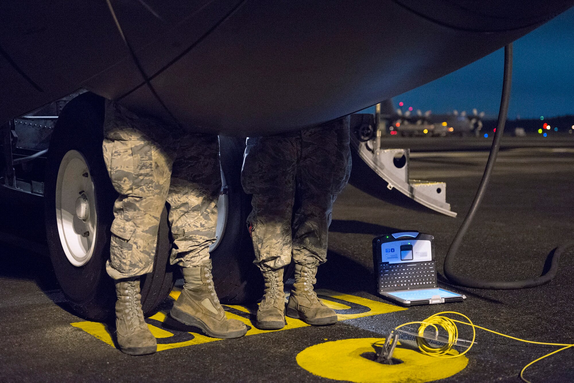 Airmen with the 374 Aircraft Maintenance Squadron inspect landing gear during Vigilant Ace 16 at Yokota Air Base, Japan, Nov. 2, 2015. The inspection included checking the aircraft for overall working condition and giving it a 72-hour seal for approved flight. These scheduled inspections ensure the aircraft is safe and reliable and allow aircraft to quickly respond to contingencies. Yokota Airmen participating in Vigilant Ace 16 train alongside aircrews flying different types of aircraft, practicing interoperability that enables aircrew members to be ready for many potential situations. (U.S. Air Force photo by Staff Sgt. Cody H. Ramirez/Released)