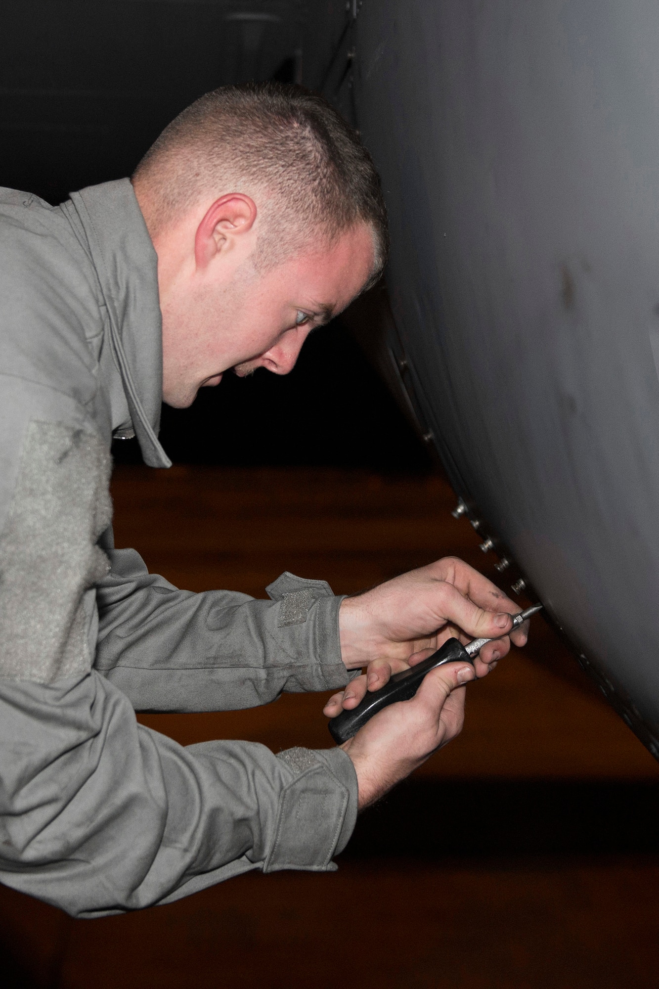 A member of the 374th Aircraft Maintenance Squadron tightens an engine panel on a C-130 Hercules during Vigilant Ace 16 at Yokota Air Base, Japan, Nov. 2,2015. Vigilant Ace is a U.S.-Republic of Korea combined exercise aimed at enhancing operational and tactical level coordination through combined and joint combat training. The exercise also provides critical training for the Airmen of the 374th Airlift Wing to maintain peace and stability in Japan and the entire Indo-Asia Pacific region. (U.S. Air Force photo by Staff Sgt. Cody H. Ramirez/Released)