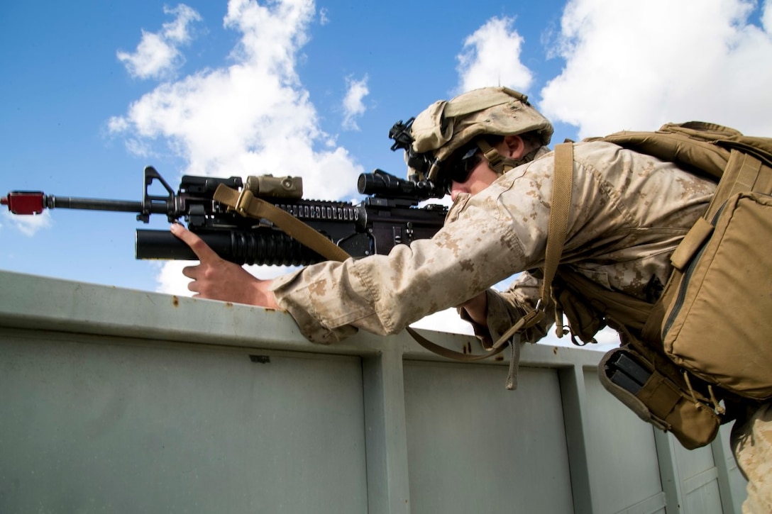 A U.S. Marine with Battalion Landing Team 2/1, 13th Marine Expeditionary Unit, helps provide security as other Marines clear buildings as part of an amphibious assault during Composite Training Unit Exercise at Marine Corps Base Camp Pendleton, Calif., Nov. 3, 2015. COMPTUEX provides the MEU ARG the opportunity to integrate naval training while also allowing focused, mission-specific training and evaluation for the Marines and their Navy counterparts. 