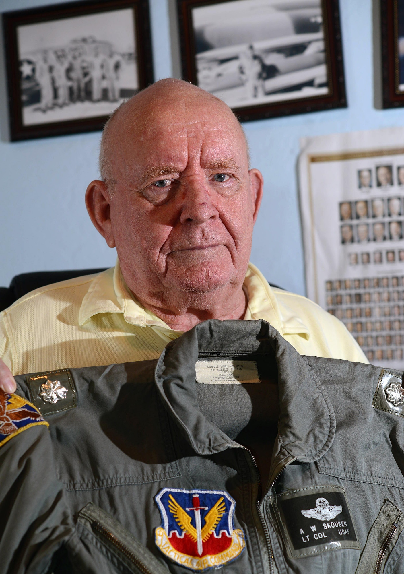 Retired Lt. Col. Alma Skousen shows off his flight suit Oct. 30, 2015, in his Mesa, Ariz., home. Skousen flew combat missions in the Korean and Vietnam wars and was awarded the Distinguished Flying Cross for acts of heroism and extraordinary achievement while participating in an aerial flight. Skousen ended his flying career with more than 6,000 flying hours. (U.S. Air Force photo/Tech. Sgt. Timothy Boyer) 