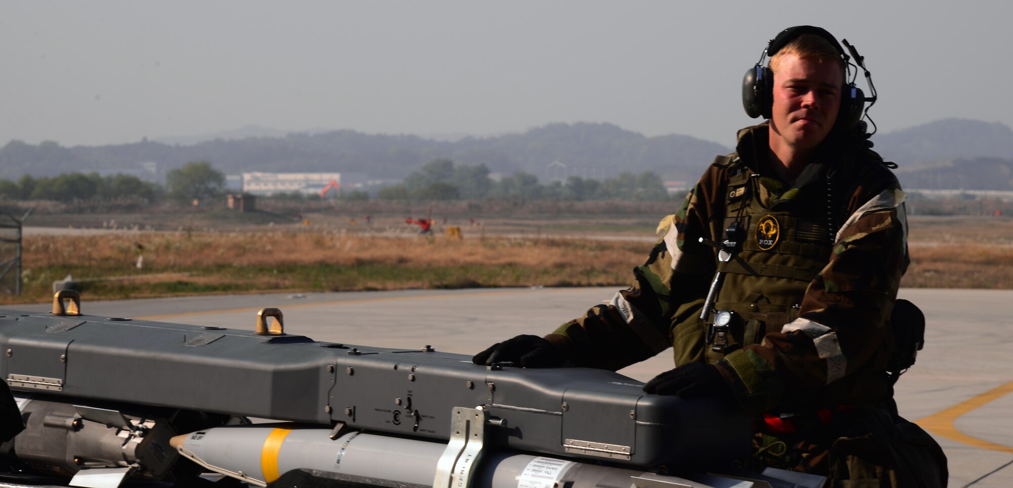 Staff Sgt. Christopher Alteri, 36th Aircraft Maintenance Unit weapons load crew team chief, guides an MJ-1 Jammer with munitions into a hardened facility before loading it to an F-16 Fighting Falcon assigned to the 36th Fighter Squadron Nov. 4, 2015, at Osan Air Base, Republic of Korea. During the large-scale exercise Vigilant Ace 16, Airmen load aircraft continuously during their 12-hour shifts. Vigilant Ace 16 is designed to enhance the interoperability of the U.S. and Republic of Korea Air Forces. (U.S. Air Force photo/Staff Sgt. Benjamin Sutton)