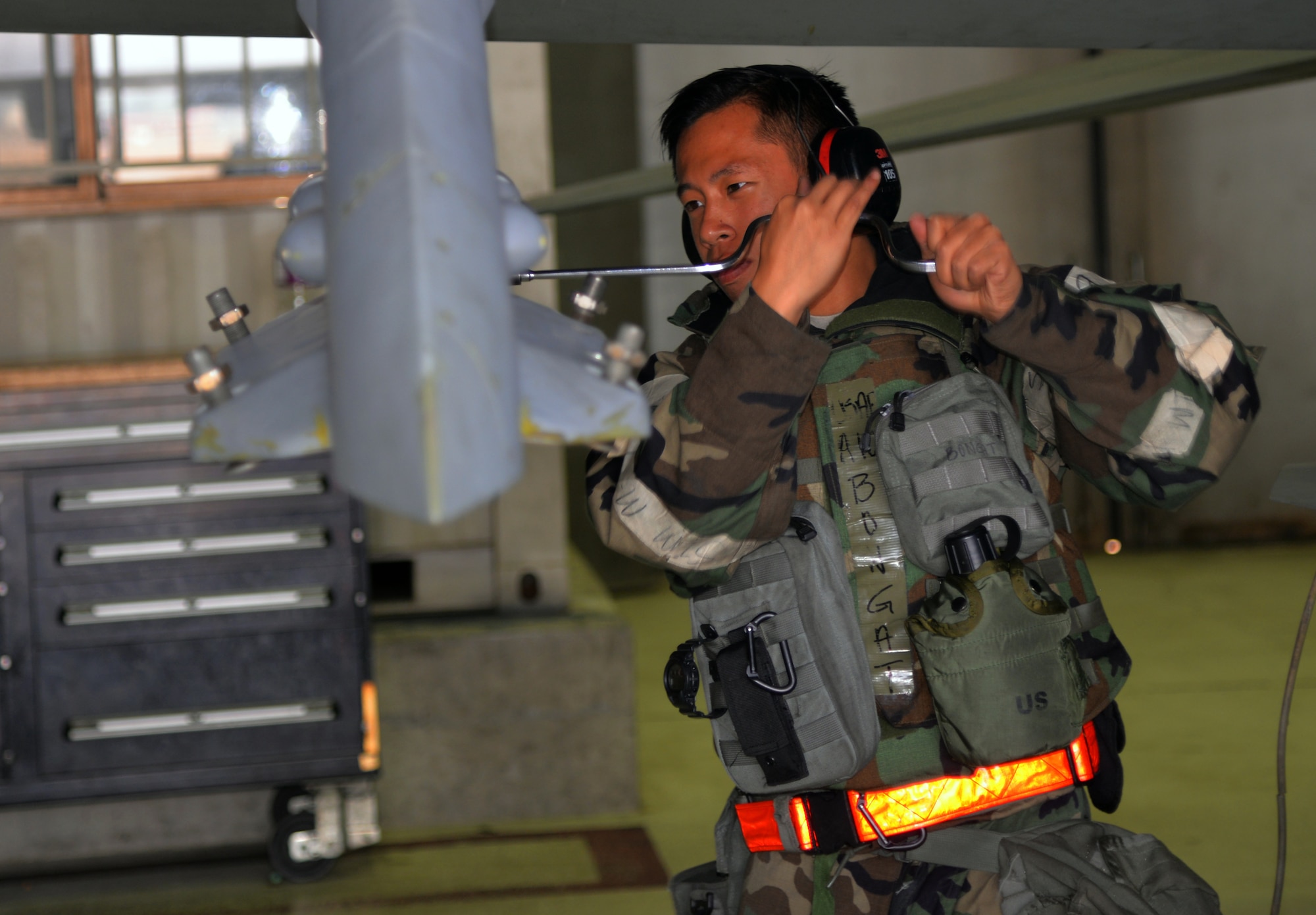 Airman 1st Class Gabriel Bongat, 36th Aircraft Maintenance Unit weapons load crew member, uses a speed handle on an F-16 Fighting Falcon assigned to the 36th Fighter Squadron Nov. 4, 2015, at Osan Air Base, Republic of Korea. Members of the 36th AMU are participating in the large-scale readiness exercise Vigilant Ace 16. During the exercise, Airmen launch and recover aircraft continuously during their 12-hour shifts. Vigilant Ace 16 is designed to enhance the interoperability of the U.S. and Republic of Korea Air Forces. (U.S. Air Force photo/Staff Sgt. Benjamin Sutton)