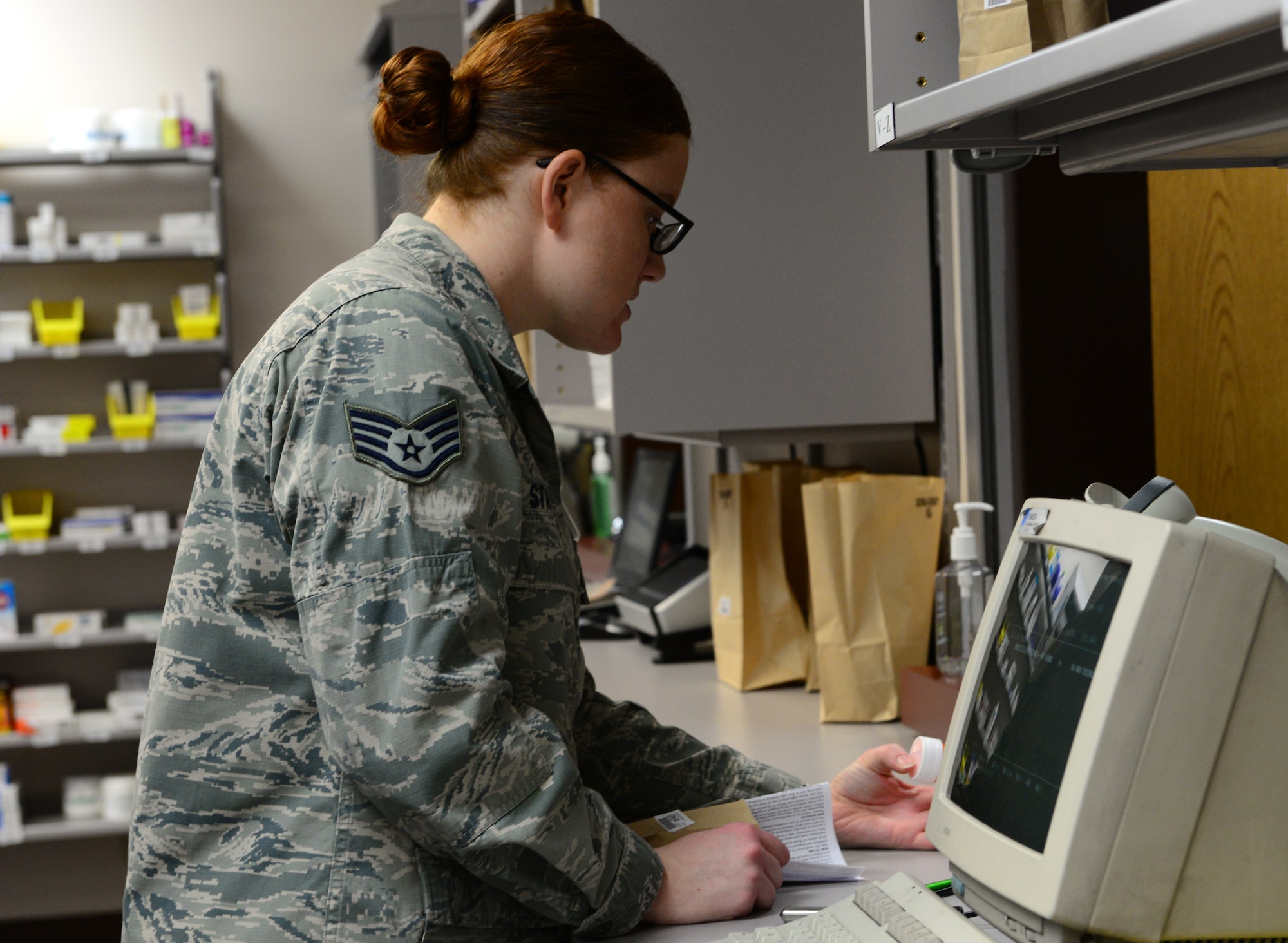 U.S. Air Force Staff Sgt. Nadine Statham, a 354th Medical Group pharmacy technician, scans a prescription for a patient Nov. 4, 2015, at Eielson Air Force Base, Alaska. Statham scans the bottles to ensure patients receive the correct medicine and amount of prescriptions. (U.S. Air Force photo by Airman 1st Class Cassandra Whitman/Released)