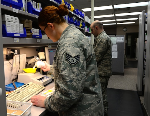 U.S. Air Force Staff Sgt. Nadine Statham, a 354th Medical Group pharmacy technician, pours pills into a bowl Nov. 4, 2015, at Eielson Air Force Base, Alaska. The bowl is on a weight machine, which automatically counts the medication and indicates when the correct amount of medication has been poured. (U.S. Air Force photo by Airman 1st Class Cassandra Whitman/Released)