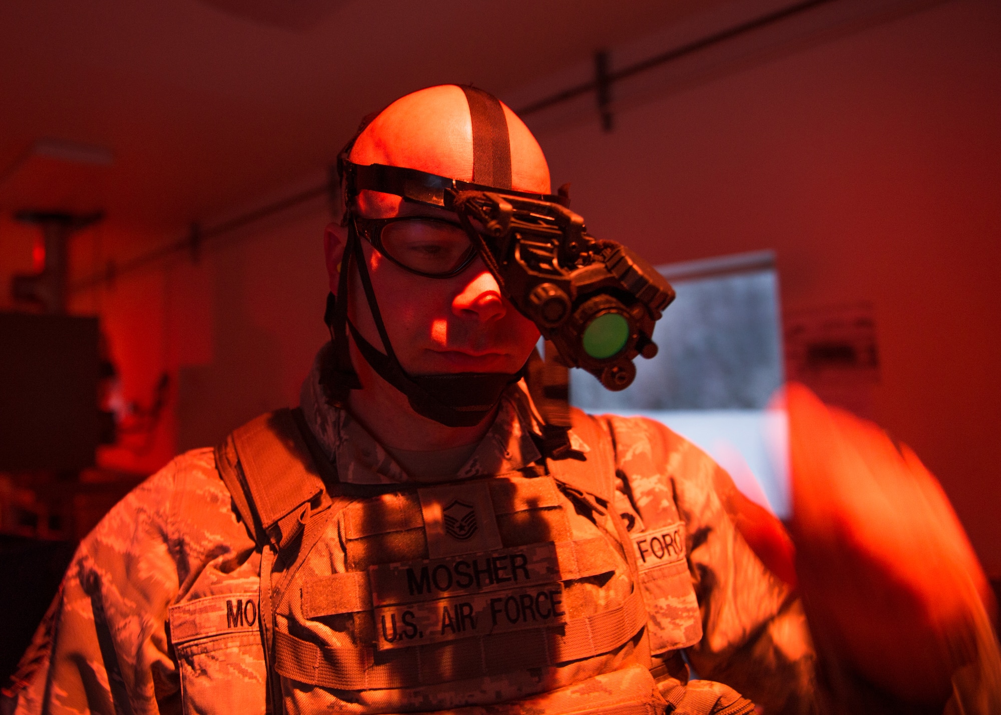 Master Sgt. Anthony Mosher, the 354th Security Forces Squadron superintendent of standards and evaluation, adjusts his night vision goggles (NVGs) during a low-light shooting course Nov. 4, 2015, at the Eielson Air Force Base, Alaska, combat arms training range. The NVGs, along with tracer rounds, flashlights and laser sights, were used during the course to ensure Airmen from the 354th Security Forces Squadron posses the proper skills to defend the base and prepare for deployments. (U.S. Air Force photo by Staff Sgt. Shawn Nickel/Released)