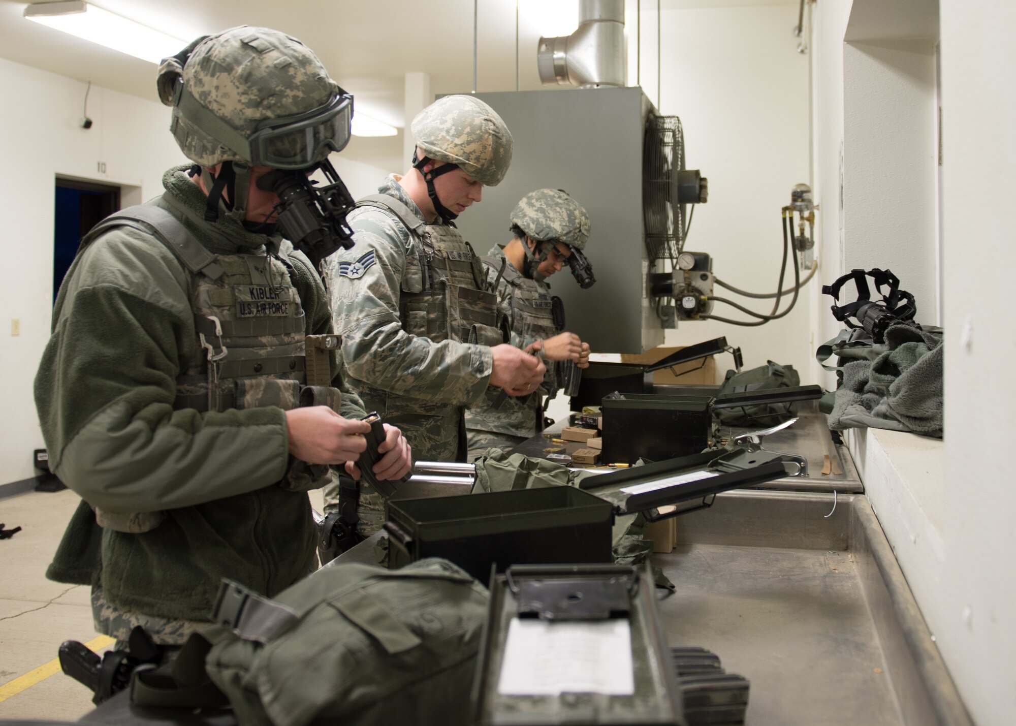 Response force members with the 354th Security Forces Squadron load magazines to shoot during a low-light qualification course Nov. 4, 2015, at the Eielson Air Force Base, Alaska, combat arms training range. A group of eight Airmen from the squadron used night vision goggles, tracer rounds, flashlights and laser sights to qualify on low-light shooting. (U.S. Air Force photo by Staff Sgt. Shawn Nickel/Released)