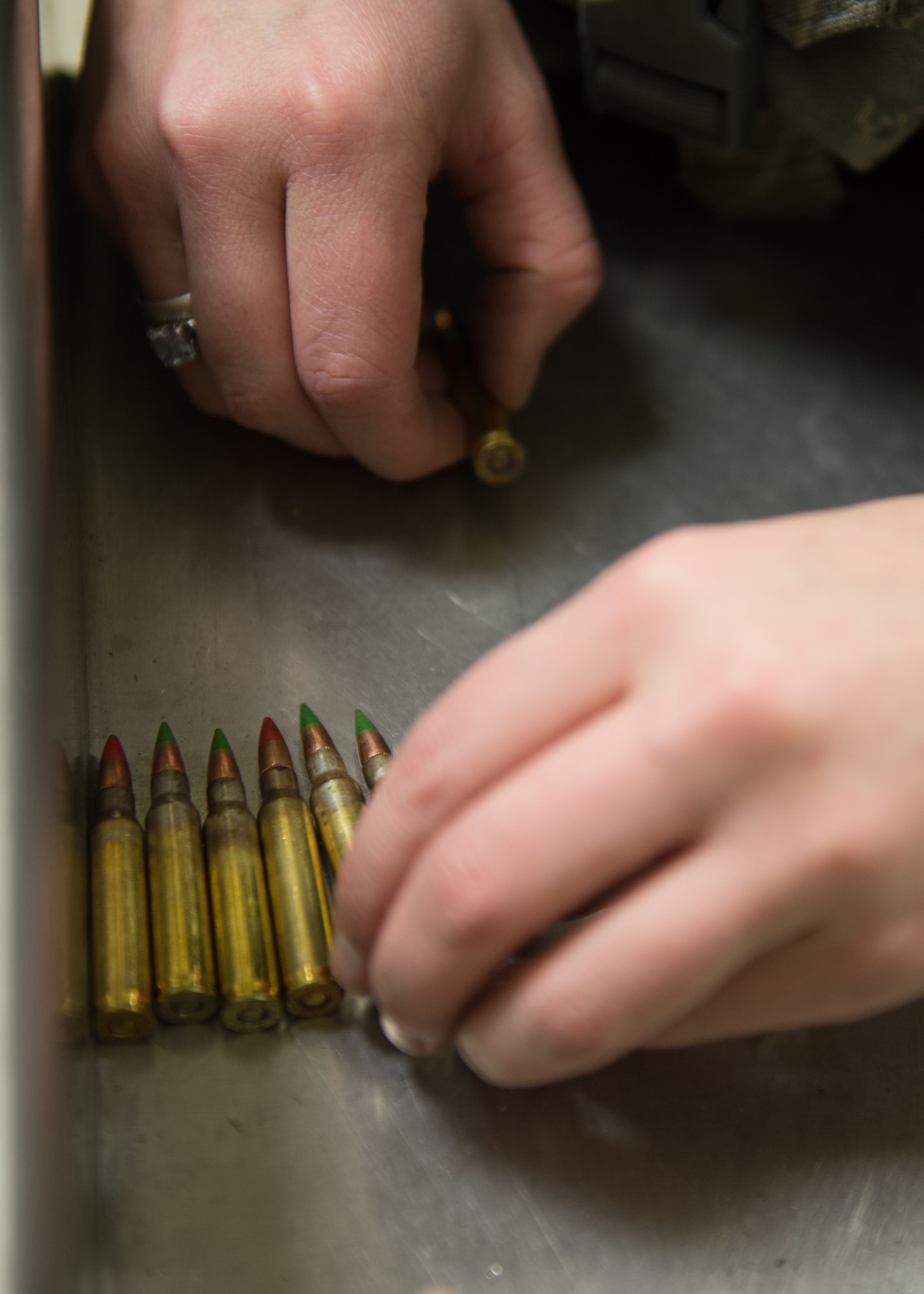 Airman 1st Class Hannah Janicki, a 354th Security Forces Squadron response force member, mixes tracer rounds with traditional ammunition to shoot during a low-light qualification course Nov. 4, 2015, at the Eielson Air Force Base, Alaska, combat arms training range. The tracers, along with night vision goggles, flashlights and laser sights, were used during the course to ensure Airmen posses the proper skills to defend the base and prepare for deployments. (U.S. Air Force photo by Staff Sgt. Shawn Nickel/Released)