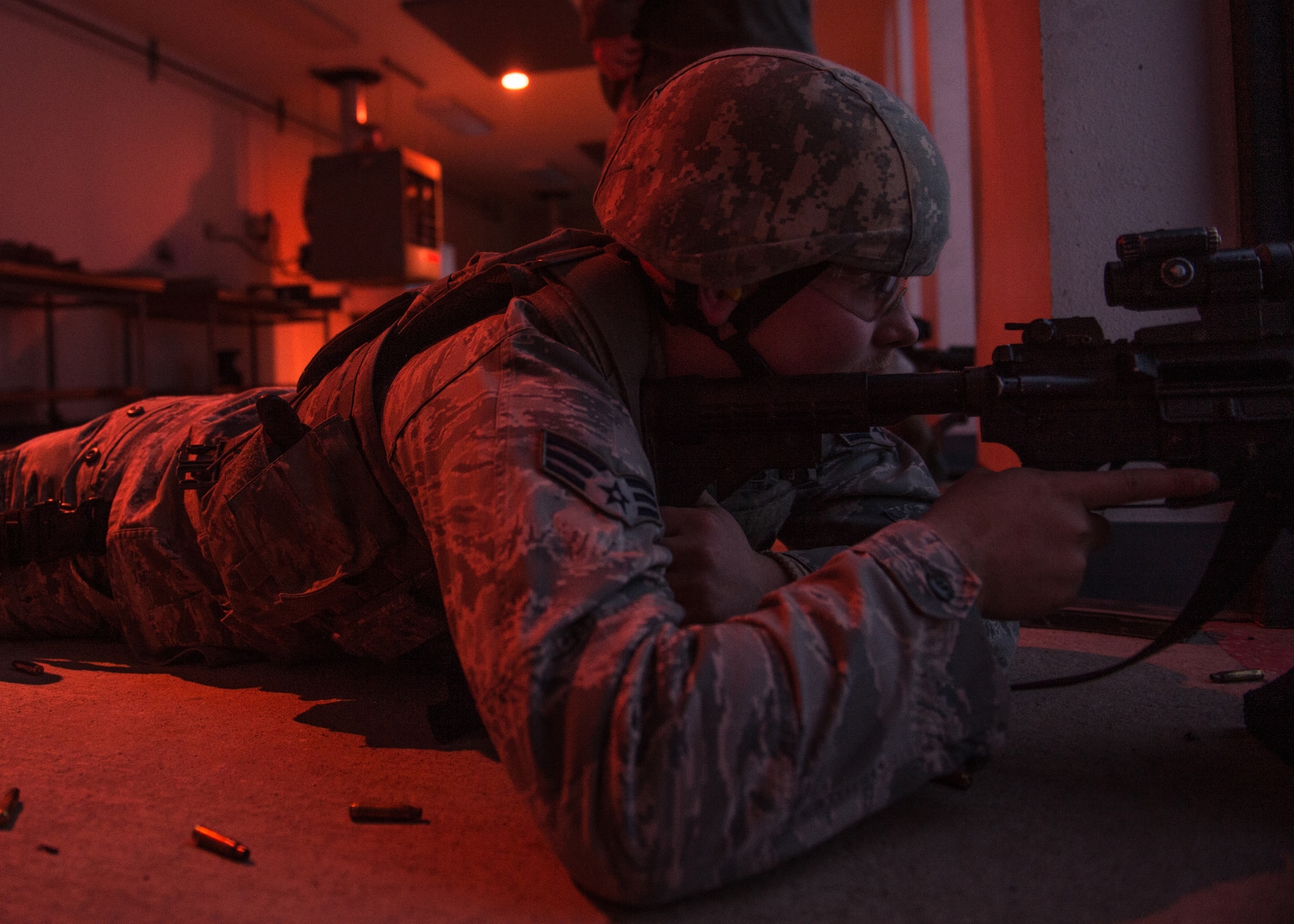 A response force member of the 354th Security Forces Squadron aims into a dark range using a laser sight and tracer rounds to qualify during a low-light shooting course Nov. 4, 2015, at the Eielson Air Force Base, Alaska, combat arms training range. The tracers and laser sight, along with night vision goggles and flashlights, were used during the course to ensure Airmen posses the proper skills to defend the base and prepare for deployments. (U.S. Air Force photo by Staff Sgt. Shawn Nickel/Released)