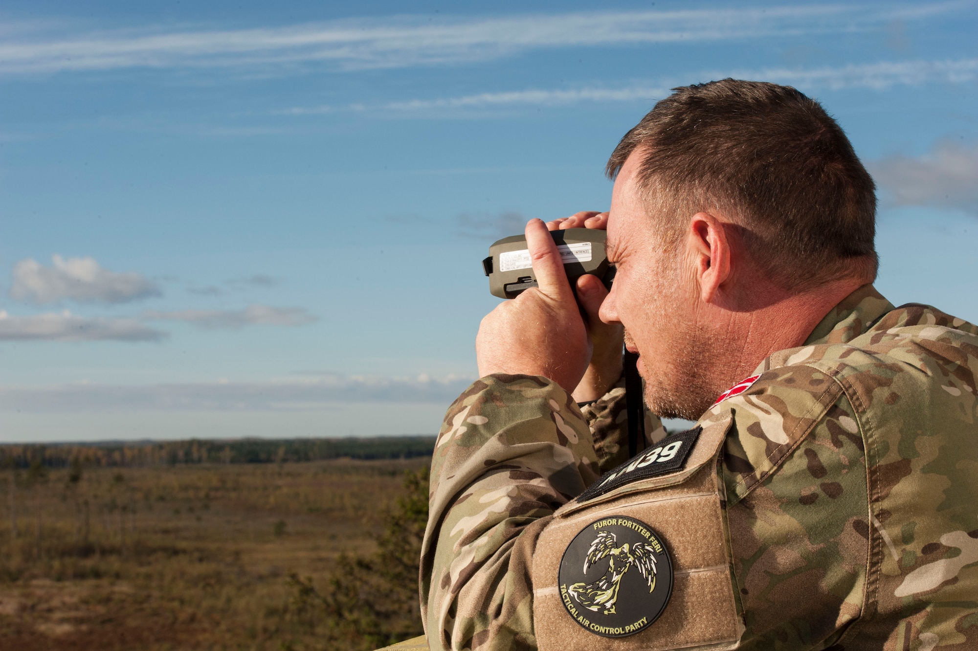 Danish army Capt. Kenn Kristensen, forward air controller supervisor, looks for a target at Tapa training range Oct. 7, 2015, near Tapa, Estonia. During the joint-training, 74th Expeditionary Fighter Squadron A-10 Thunderbolt II attack aircraft, deployed from Moody Air Force Base, Ga., supported the joint terminal air controllers with close-air support against simulated hostile targets. (U.S. Air Force photo by Andrea Jenkins/Released)