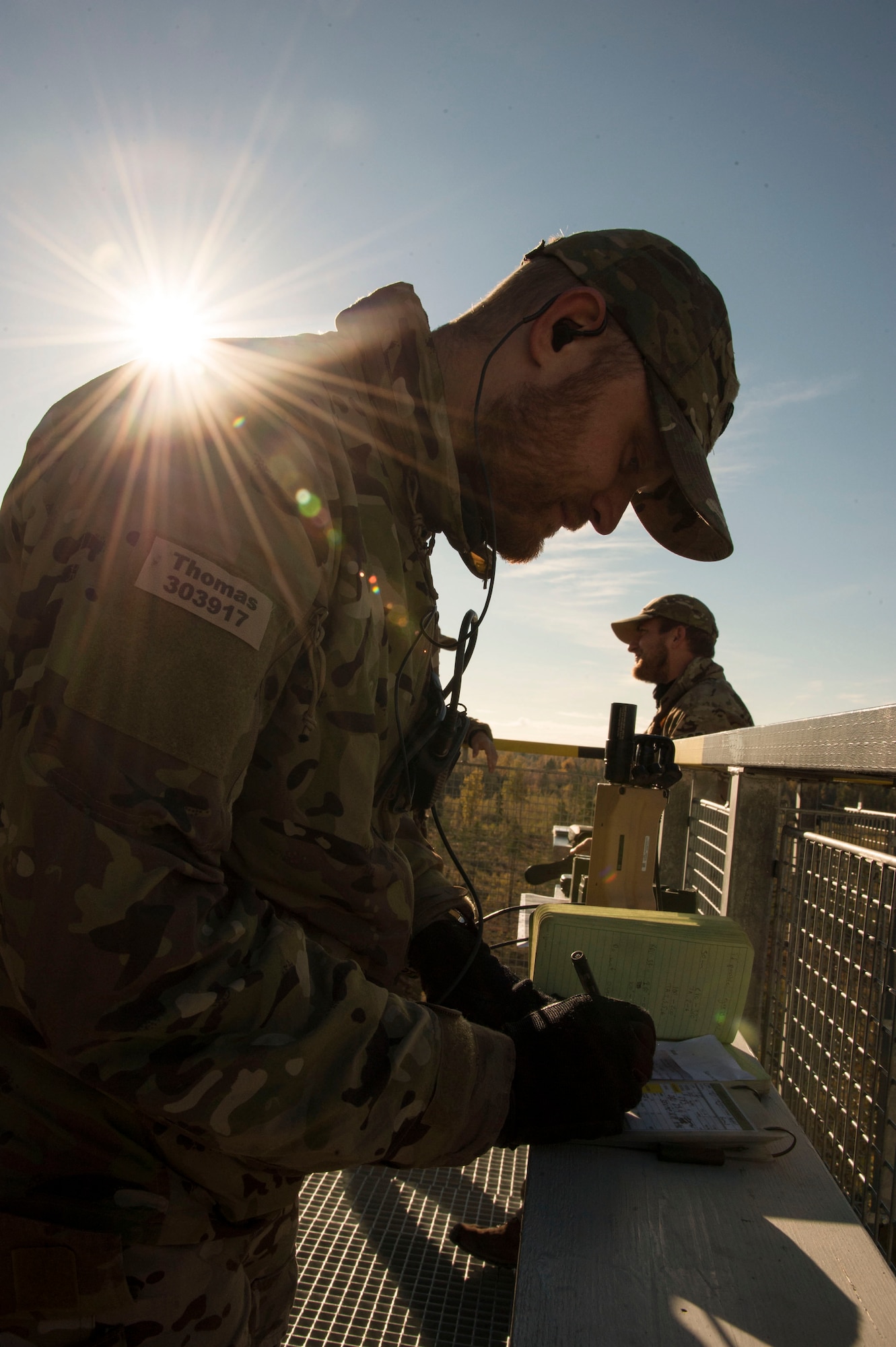 Danish army 1st Lt. Thomas Anderson, forward air controller, writes down radio frequency numbers at Tapa training range Oct. 7, 2015, near Tapa, Estonia. During the joint-training, 74th Expeditionary Fighter Squadron A-10 Thunderbolt II attack aircraft, deployed from Moody Air Force Base, Ga., supported the joint terminal air controllers with close-air support against simulated hostile targets. (U.S. Air Force photo by Andrea Jenkins/Released)