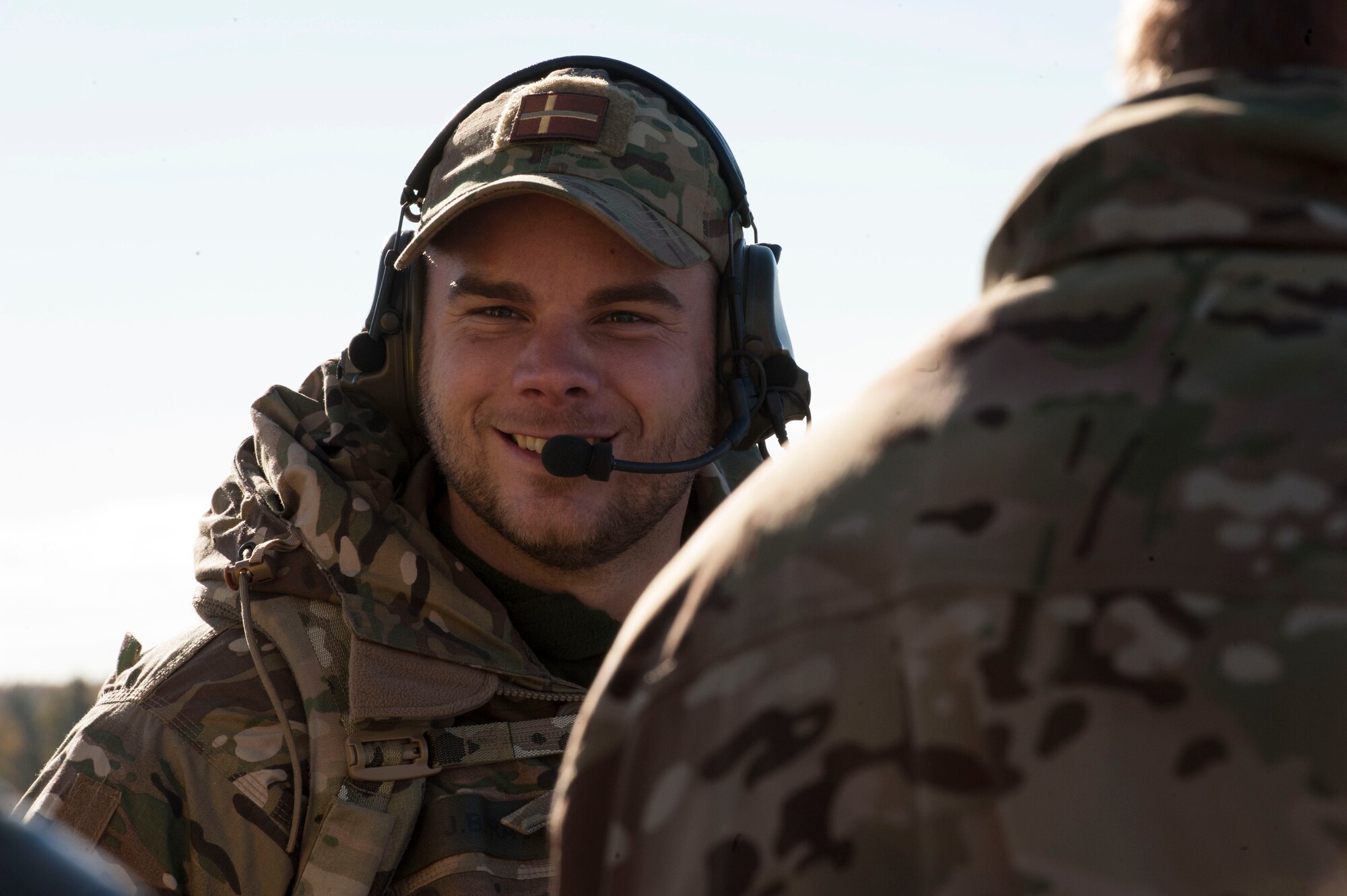 Danish army 1st Lt. Jakob Ravn, forward air controller, talks to a 74th Expeditionary Fighter Squadron pilot on the radio at Tapa training range Oct. 7, 2015, near Tapa, Estonia. During the joint-training, A-10 Thunderbolt II attack aircraft, deployed from Moody Air Force Base, Ga., supported the joint terminal air controllers with close-air support against simulated hostile targets. (U.S. Air Force photo by Andrea Jenkins/Released)