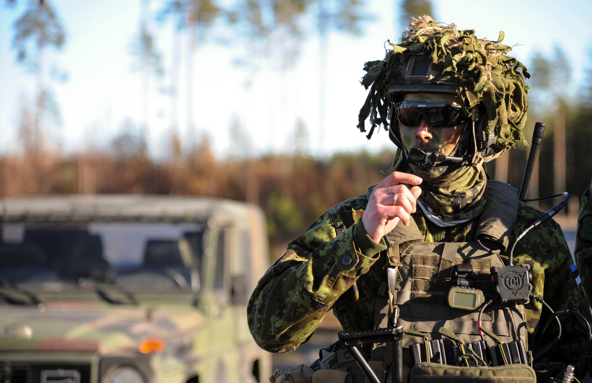 An Estonian air force joint terminal air controller, checks his radio prior to a joint-training exercise at Tapa training range Oct. 28, 2015, near Tapa, Estonia. During the training, 74th Expeditionary Fighter Squadron A-10 Thunderbolt II attack aircraft, deployed from Moody Air Force Base, Ga., supported the Estonian JTACs with close-air support against simulated hostile targets. (U.S. Air Force photo by Andrea Jenkins/Released)
