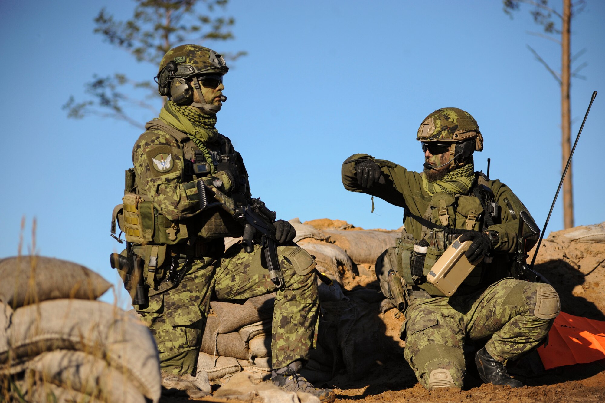 Estonian joint terminal attack controllers wait for 74th Expeditionary Fighter Squadron A-10 Thunderbolt II attack aircraft to check into the airspace prior to a close-air support training mission at Tapa training range Oct. 28, 2015, near Tapa, Estonia. During the training, A-10s deployed from Moody Air Force Base, Ga., supported the JTACs with close-air support against simulated hostile targets. (U.S. Air Force photo by Andrea Jenkins/Released)