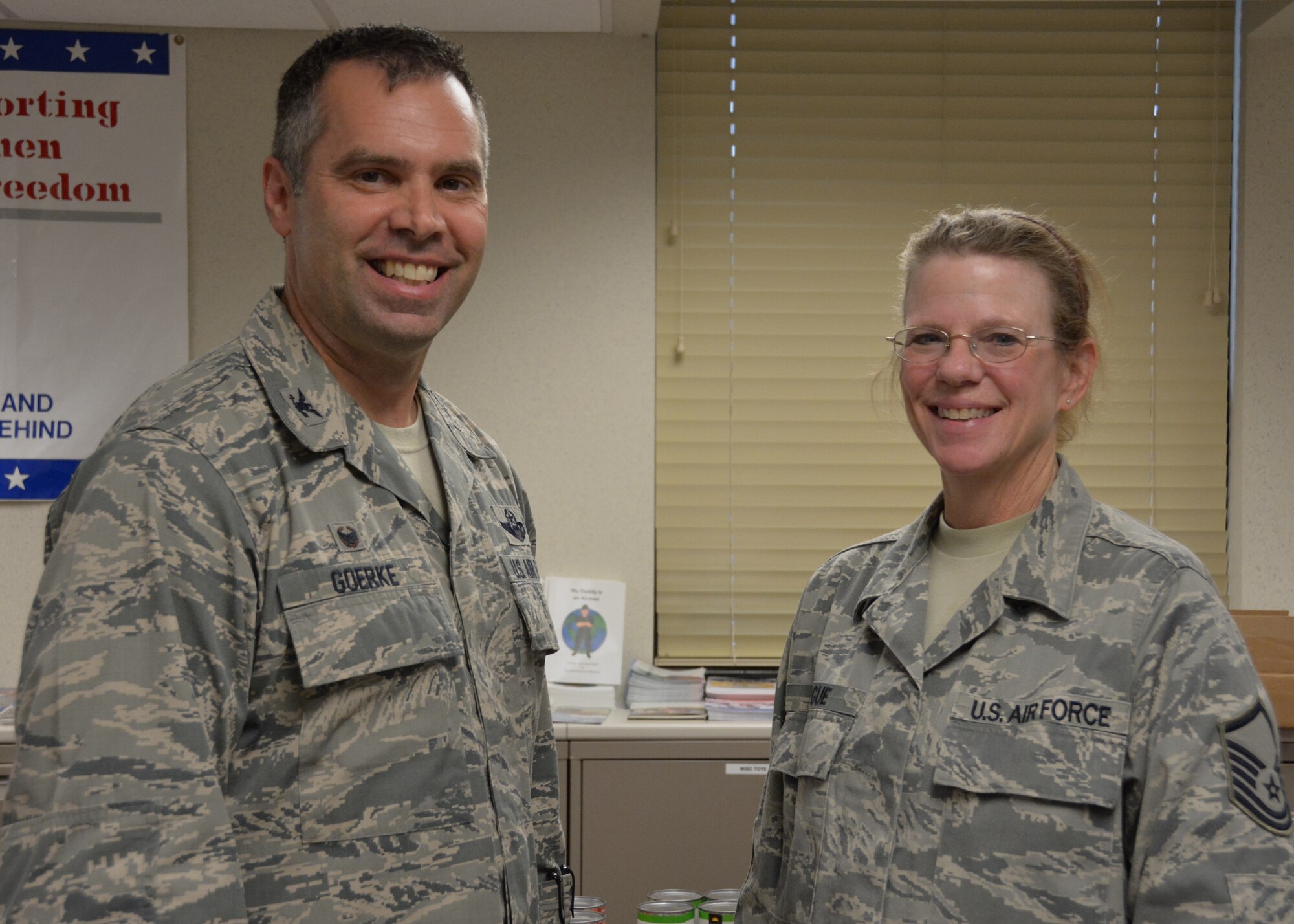 Col. Karl Goerke, 932nd Airlift Wing commander, thanked Master Sgt. Deb Teague for her efforts to take care of the Airmen and families assigned to the 932nd Airlift Wing at Scott Air Force Base, Illinois. Teague and her team gathered donations of non-perishable food items and gift cards that were used to build holiday meal baskets. The baskets, which provide everything needed to prepare a home-cooked meal, will be distributed to families who could use a little extra support during the holiday season. Master Sgt. Teague will retire on Dec. 1, 2015 after more than 31 years of dedicated service. (U.S. Air Force photo by Tech. Sgt. Jodi Ames)