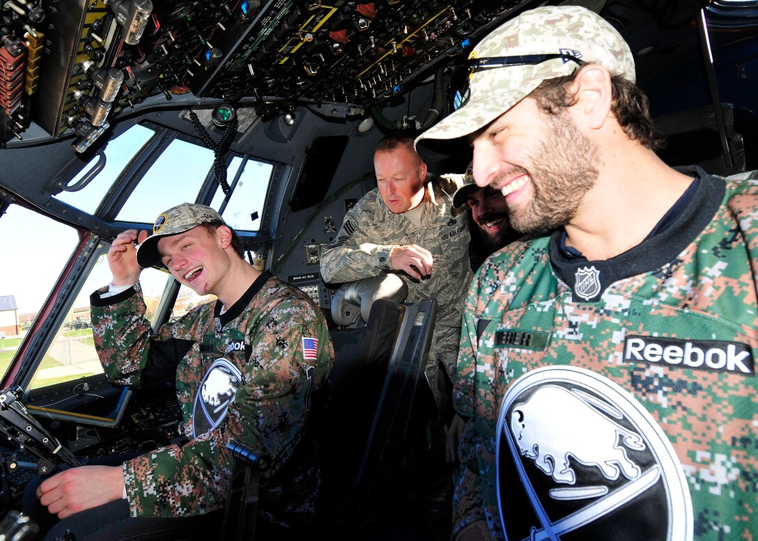 Buffalo Sabres players Jack Eichel (left), and Mike Weber (right),  talk with Chief Master Sgt. Dave Eschborn, superintendent, 914th Aircraft Maintenance Squadron, inside the flight deck of a C-130 Hercules aircraft at the Niagara Falls Air Reserve Station, N.Y. on November 4, 2015. Some members of the NHL team visited the base to thank the veterans for their service and also included a tour of the aircraft and various other interactive displays designed to educate on the 914th Airlift Wing's mission capabilities. (U.S. Air Force photo by Peter Borys)