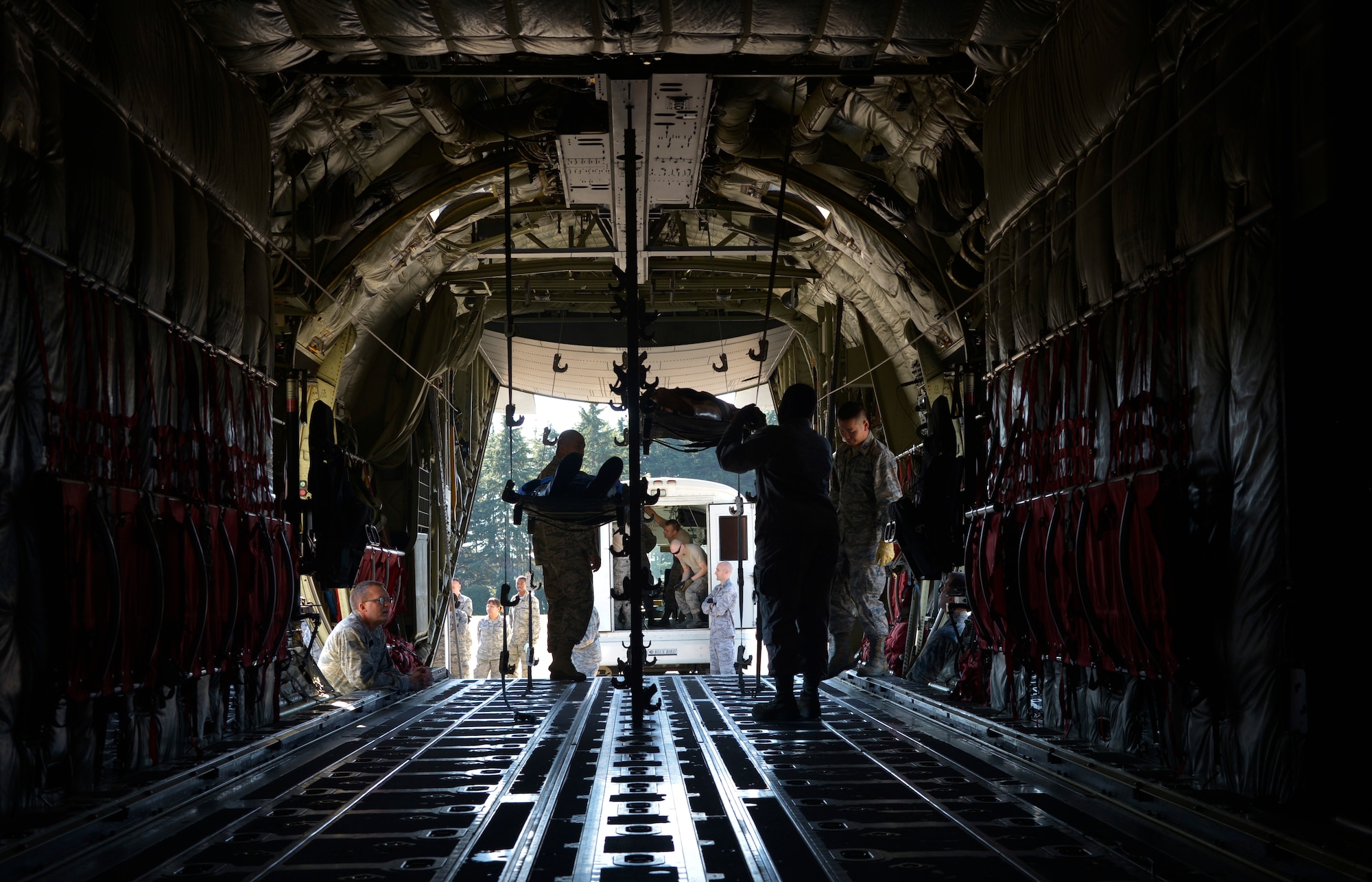 Airmen from the 374th Medical Group practice transporting simulated injured personnel from a C-130J Super Hercules, assigned to the California Air National Guard 146th Airlift Wing, for a medical evacuation training scenario during a medical evacuation training scenario at Yokota Air Base, Japan, Nov. 4, 2015. The medevac training consisted of litter carry scenarios, an obstacle course and high-deck patient loading platform vehicle training. As the Western Pacific mobility hub, Yokota Air Base will be a key location in the event of regional instability, and this exercise gives the installation a chance to test those capabilities in a realistic scenario. (U.S. Air Force photo by Senior Airman David Owsianka/Released)