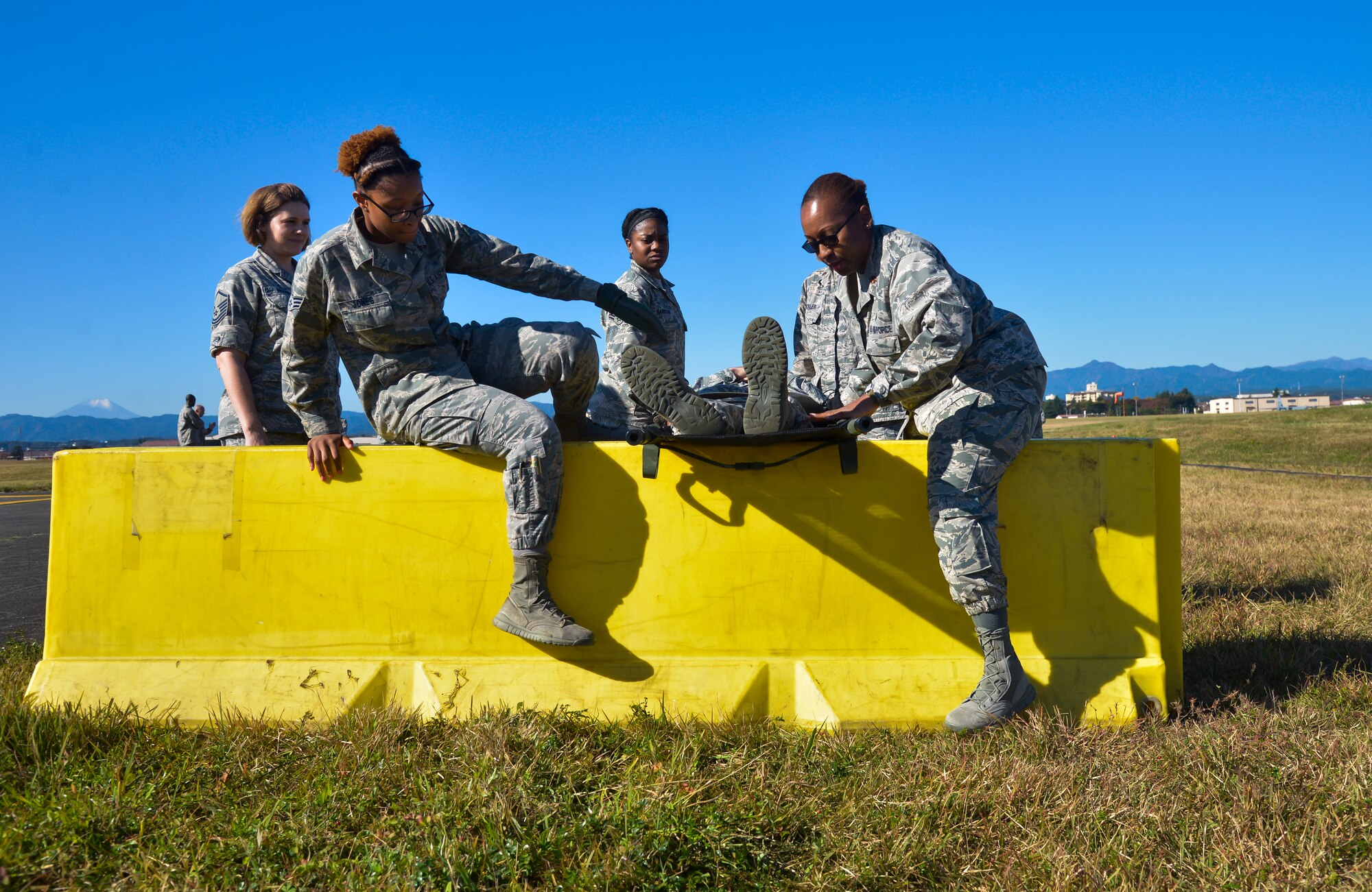 Airmen from the 374th Medical Group take part in a medical evacuation training scenario obstacle course at Yokota Air Base, Japan, Nov. 4, 2015. The medical training was completed as part of the Samurai Readiness Inspection being conducted in conjunction with the wing’s participation in Exercise VIGILANT ACE 16 to provide critical training for the Airmen of the 374th Airlift Wing to maintain peace and stability in Japan and the entire Indo-Asia Pacific region. . (U.S. Air Force photo by Senior Airman David Owsianka/Released)