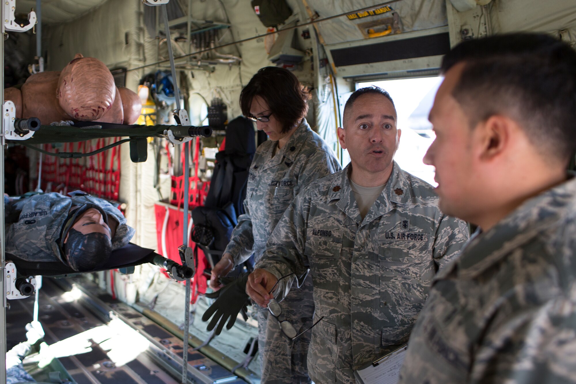 (Center) Maj. Antonio Alfonso, 374th Medical Group, helps prepare Airmen for a simulated medical evacuation at Yokota Air Base, Japan, Nov. 4, 2015. The training consisting of litter carry scenarios, an obstacle course and high-deck patient loading platform vehicle training was held as part of a Samurai Readiness Inspection held in conjunction with the wing’s participation in Exercise VIGILANT ACE 16 to provide critical training for the Airmen of the 374th Airlift Wing to maintain peace and stability in Japan and the entire Indo-Asia Pacific region. (U.S. Air Force photo by Osakabe Yasuo/Released)