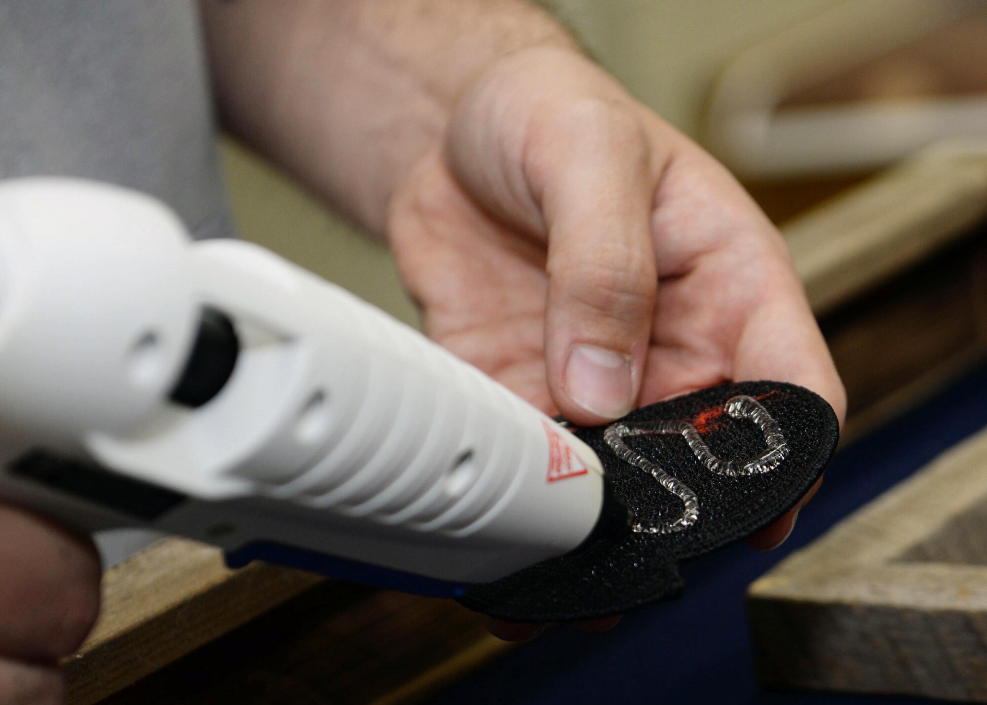 Joe Altergott, 28th Force Support Squadron visual information specialist, builds a shadowbox at Ellsworth Air Force Base, S.D., Oct. 23, 2015. The gift was made for retired Lt. Col. Dick Cole, one of two surviving Doolittle Raiders, and included multiple squadron patches from Ellsworth, a photo of a 37th Bomb Squadron aircrew, bomb pins, a flag and a certificate showing authenticity from a combat mission flown on Cole’s 100th birthday. (U.S. Air Force photo by Senior Airman Rebecca Imwalle/Released)