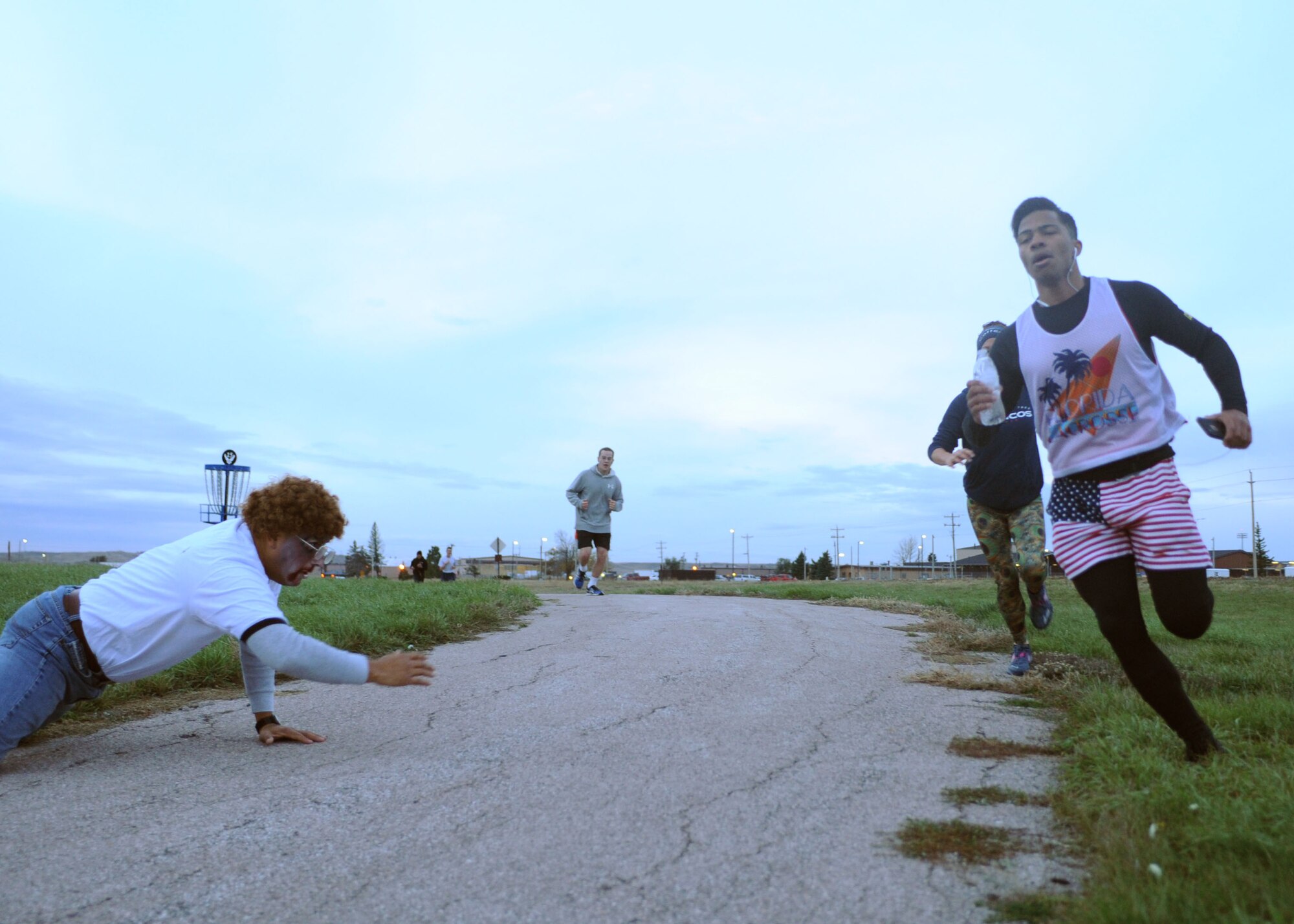Airman 1st Class Robert Connolly, 28th Force Support Squadron services apprentice, evades zombie actor Capt. Jesus Lopez, 28th FSS sustainment services flight officer in charge, during a Zombie 5k run at Ellsworth Air Force Base, S.D., Oct. 30, 2015. Approximately 110 people participated in the event, which took place at Ellsworth’s lakes track. (U.S. Air Force photo by Airman Sadie Colbert/Released)