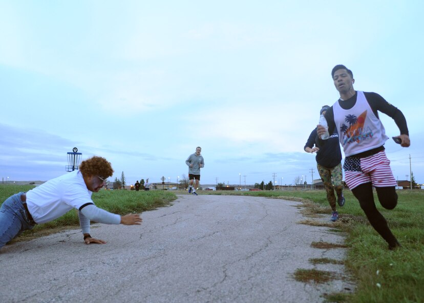 Airman 1st Class Robert Connolly, 28th Force Support Squadron services apprentice, evades zombie actor Capt. Jesus Lopez, 28th FSS sustainment services flight officer in charge, during a Zombie 5k run at Ellsworth Air Force Base, S.D., Oct. 30, 2015. Approximately 110 people participated in the event, which took place at Ellsworth’s lakes track. (U.S. Air Force photo by Airman Sadie Colbert/Released)