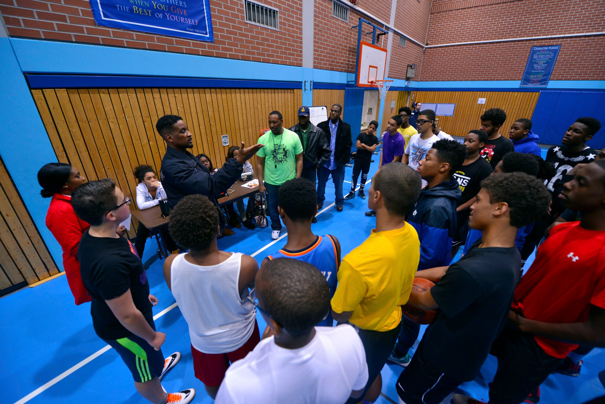 Participants in the Work Accountability Responsibility Respect Integrity Opportunity Represent (WARRIOR) Program listen to mentors from the local community during an operation night hoops event Oct. 30, 2015, at Ramstein Air Base Germany. The WARRIOR Program is open to males ages 13-18 and aims to engage young men in discussions unique to the challenges they face while progressing into manhood. (U.S. Air Force photo/Staff Sgt. Sharida Jackson)