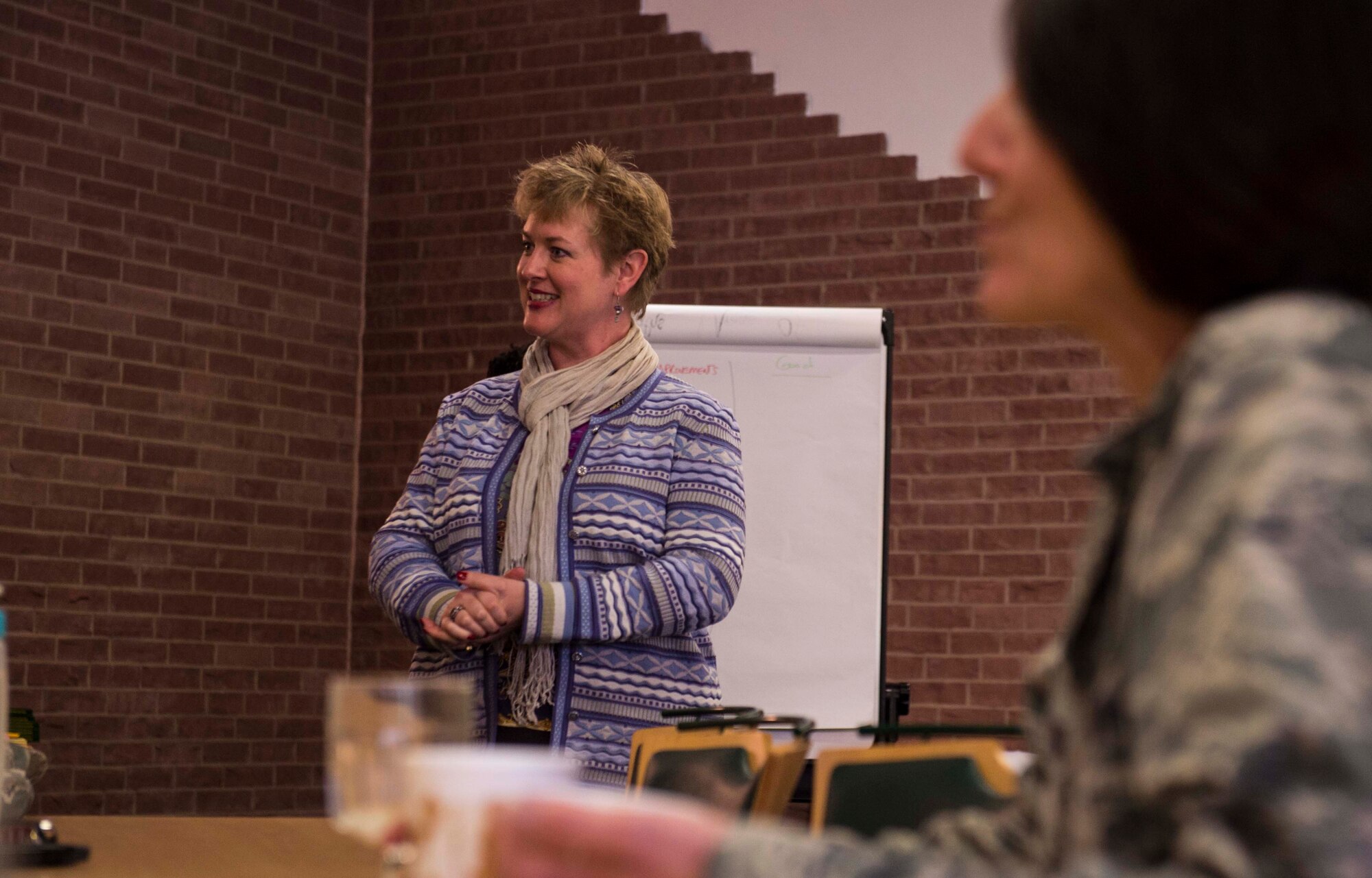 Barbara Cox, Family Advocacy outreach manager, leads a group discussion as service members get the chance to voice their opinion about base programs during the Caring for People Forum at Ramstein Air Base, Germany, Nov. 4, 2015. The forum is an annual event that gives service members and their families a more personable way of gleaning insight into the needs of the installation’s community. (U.S. Air Force photo/Staff Sgt. Sara Keller)