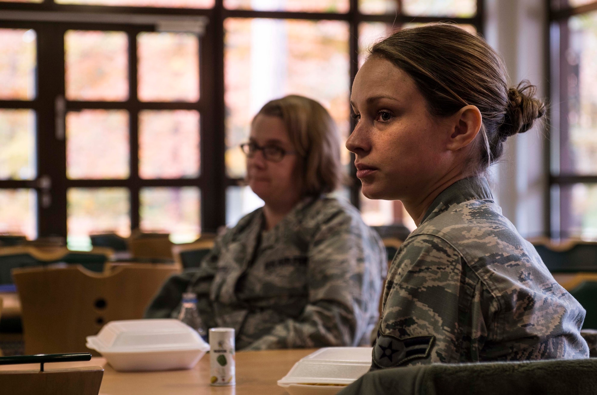 Airman First Class Maddison Hawkins, 86th Medical Support Squadron pharmacy technician, listen as other group members speak about their concerns about the base during the Caring for People Forum at Ramstein Air Base, Germany, Nov. 4, 2015. The event was a four-part forum aimed at improving the effectiveness of Ramstein’s Airmen support and quality of life programs which allowed Airmen and their families voice their opinions about base programs. Each part of the forum was designated for different audience demographics including s spouses group,  a young Airmen group and single parent group.  (U.S. Air Force photo/Staff Sgt. Sara Keller)