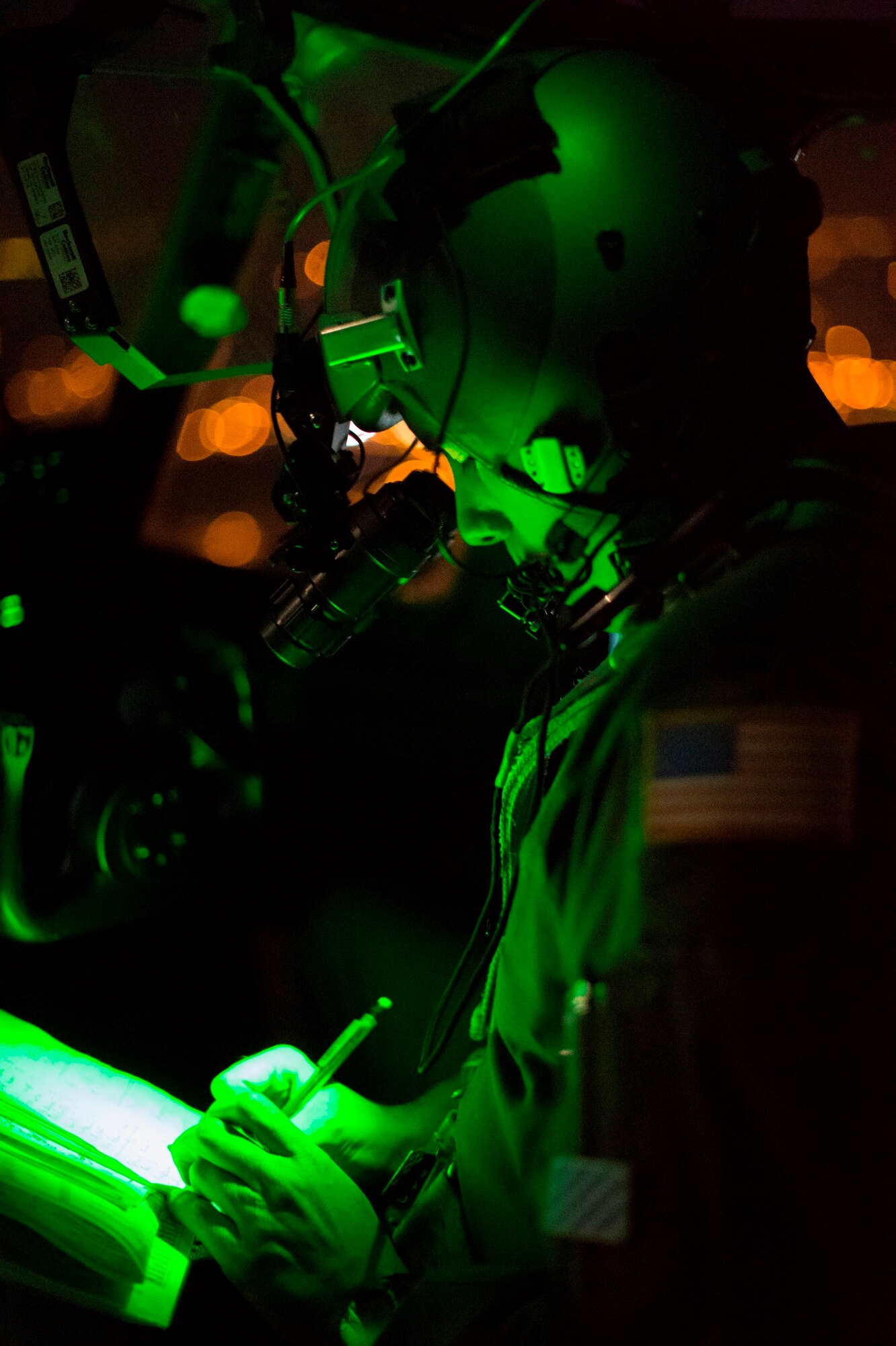 A U.S. Air Force C-130J Super Hercules pilot writes down coordinates of anti-aircraft ‘threats’ as part of training during Aviation Detachment 16-1, Oct. 28, 2015 above Powidz, Poland.  During the flying training deployment pilots flew in the day and night to ensure mission capabilities are available in any situation. (U.S. Air Force photo/Senior Airman Damon Kasberg)
