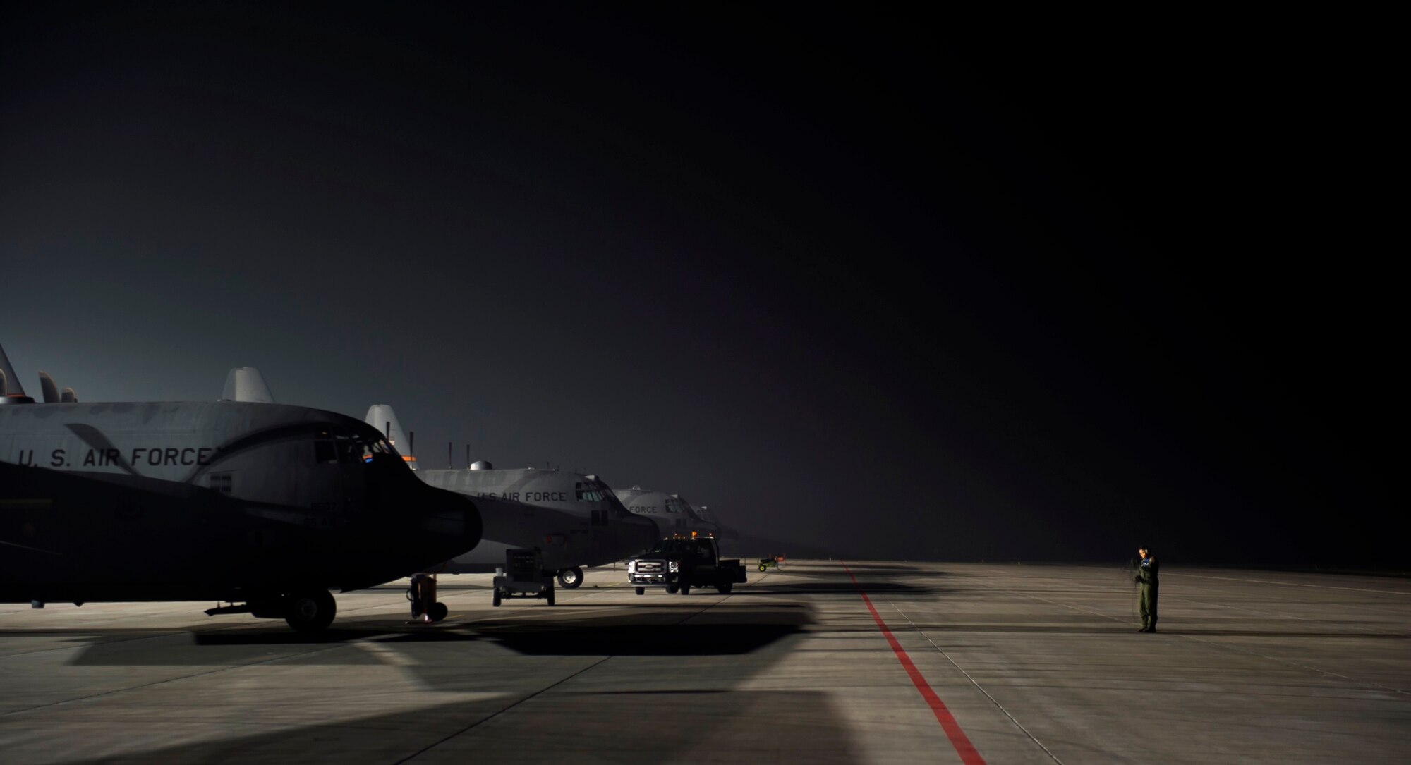 A U.S. Air Force 37th Airlift Squadron loadmaster prepares her communication equipment prior to take off Oct. 30, 2015, at Powidz Air Base, Poland. Loadmasters have a variety of responsibilities in the aircraft, including calculating the weight balance and rigging cargo for airdrops. (U.S. Air Force photo/Senior Airman Damon Kasberg)
