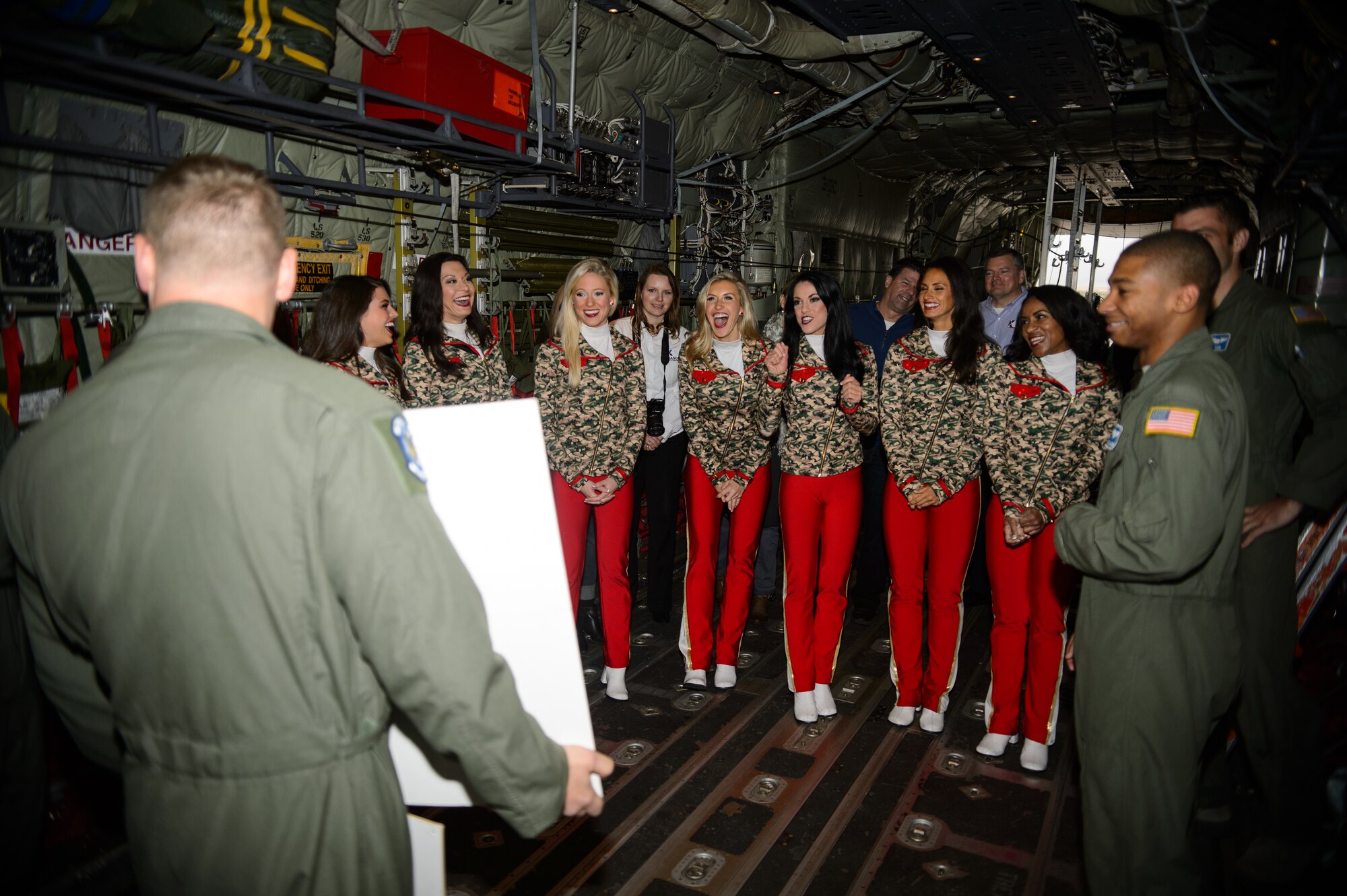 Airmen from the 37th Airlift Squadron shares jokes with Kansas City Chiefs cheerleaders during a base tour Nov. 2, 2015, at Ramstein Air Base, Germany. The cheerleaders are slated to return to perform and provide a clinic for the families of the Kaiserslautern Military Community. (U.S.  Air Force photo/Staff Sgt. Armando A. Schwier-Morales)