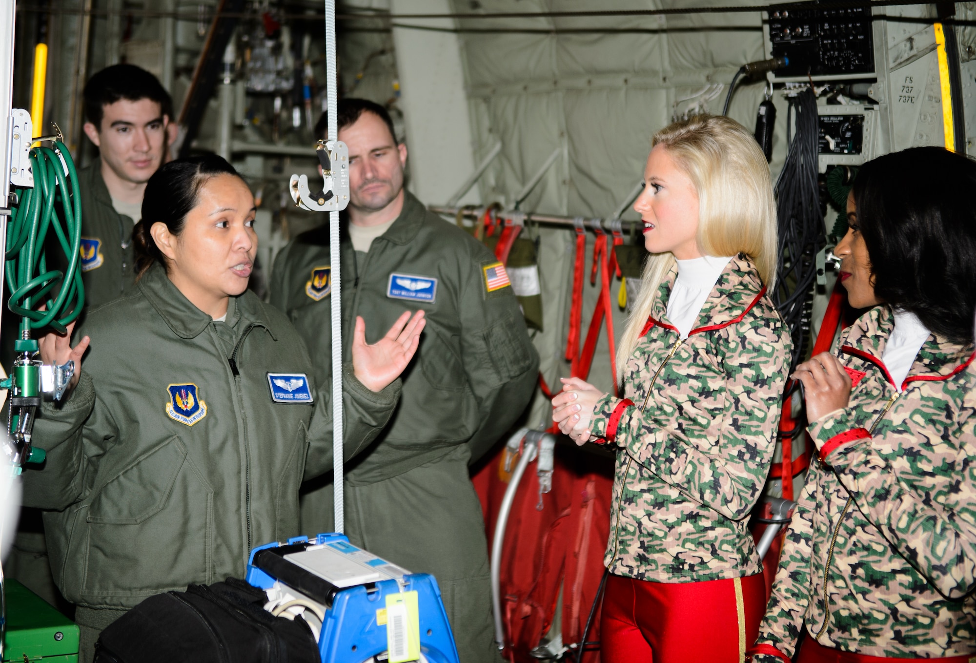 Capt. Stefhanie Jimenez, 86th Aeromedical Evacuation Squadron flight nurse, explains her job to Kansas City Chiefs cheerleaders during a base tour Nov. 2, 2015, at Ramstein Air Base, Germany. The cheerleaders learned about Ramstein’s history, mission and capabilities during the tour. (U.S.  Air Force photo/Staff Sgt. Armando A. Schwier-Morales)