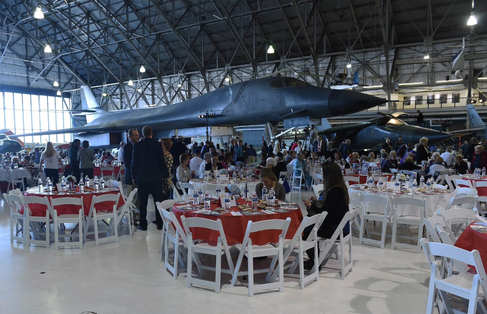 Crowds of past and present service members, along with community leaders, begin finding their seats during the Aurora Veteran Salute event Nov. 4, 2015, at Wings Over the Rockies Air and Space Museum. The event is held every year to honor WWII veterans and celebrate the 70th anniversary of the end of WWII. (U.S. Air Force photo by Airman 1st Class Samantha Meadors/Released)