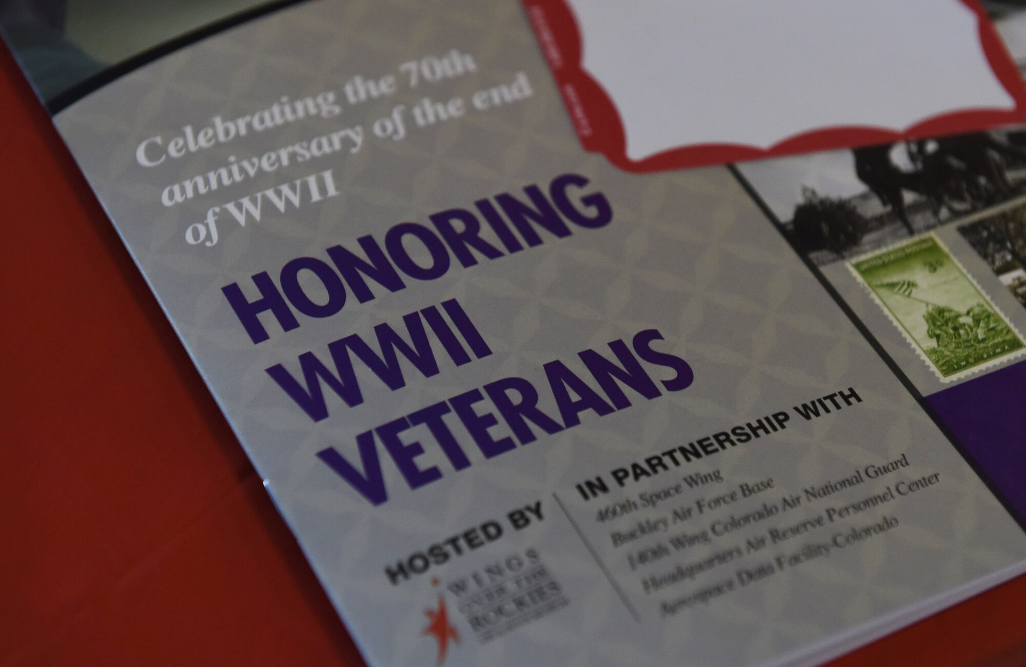 An Aurora Veteran Salute pamphlet is placed at each seat Nov. 4, 2015, at Wings Over the Rockies Air and Space Museum. The event is held every year to honor WWII veterans and celebrate the 70th anniversary of the end of WWII. (U.S. Air Force photo by Airman 1st Class Samantha Meadors/Released)