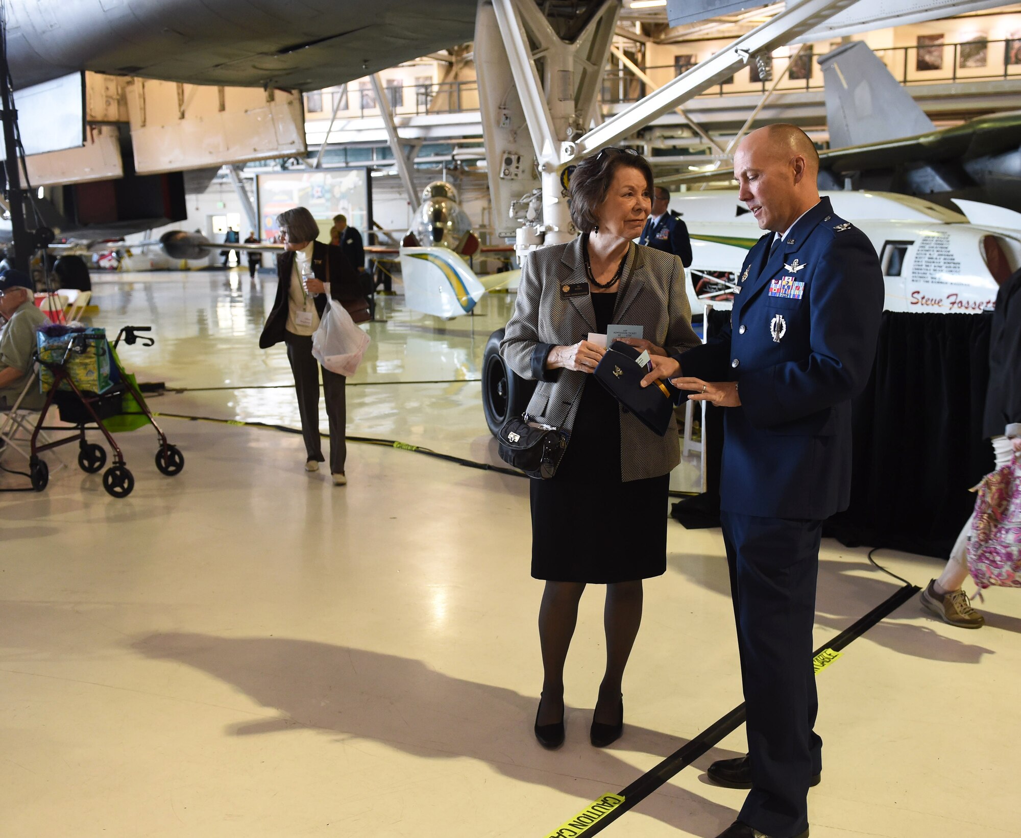 Col. Scott Romberger, 460th Vice Wing commander, and Representative Su Ryden, State House District 36, talk during the Aurora Veteran Salute event Nov. 4, 2015, at Wings Over the Rockies Air and Space Museum. The event is held every year to honor WWII veterans and celebrate the 70th anniversary of the end of WWII. (U.S. Air Force photo by Airman 1st Class Samantha Meadors/Released)