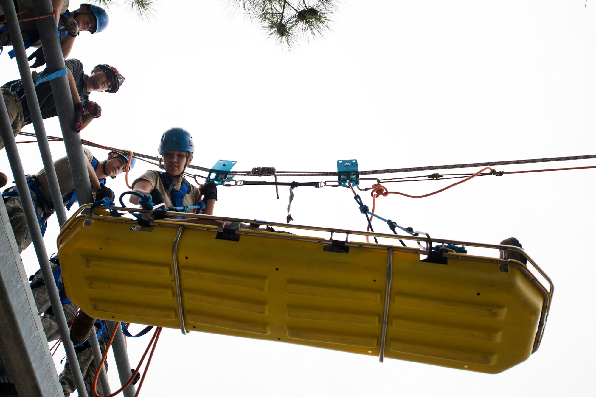 Airman 1st Class Tamara Ortiz, 11th Civil Engineer Squadron fire department exercise rescue spotter, positions herself before going across two building during a Department of Defense Rescue Technical Course scenario at Joint Base Andrews, Md., Fire Department Training Area, Nov. 2, 2015. There is a hands-on and written portion to the course that trainees are evaluated on throughout the class. It is a DOD course that is taught by and to other United States military branches. (U.S. Air Force photo by Airman 1st Class Philip Bryant/Released))