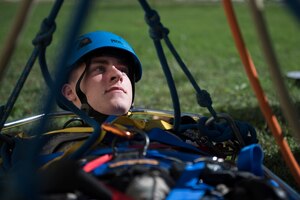 Airman 1st Class Dean Adamczyk, 11th Civil Engineer Squadron exercise rescue patient, lies in a Stokes basket stretcher during a Department of Defense Rescue Technical Course outside the William A. Jones III Building at Joint Base Andrews, Md., Oct. 30, 2015. Adamczyk, and every member of the 10-Airman class, took their turn simulating each role of a rescue scenario. (U.S. Air Force photo by Airman 1st Class Philip Bryant/Released) 