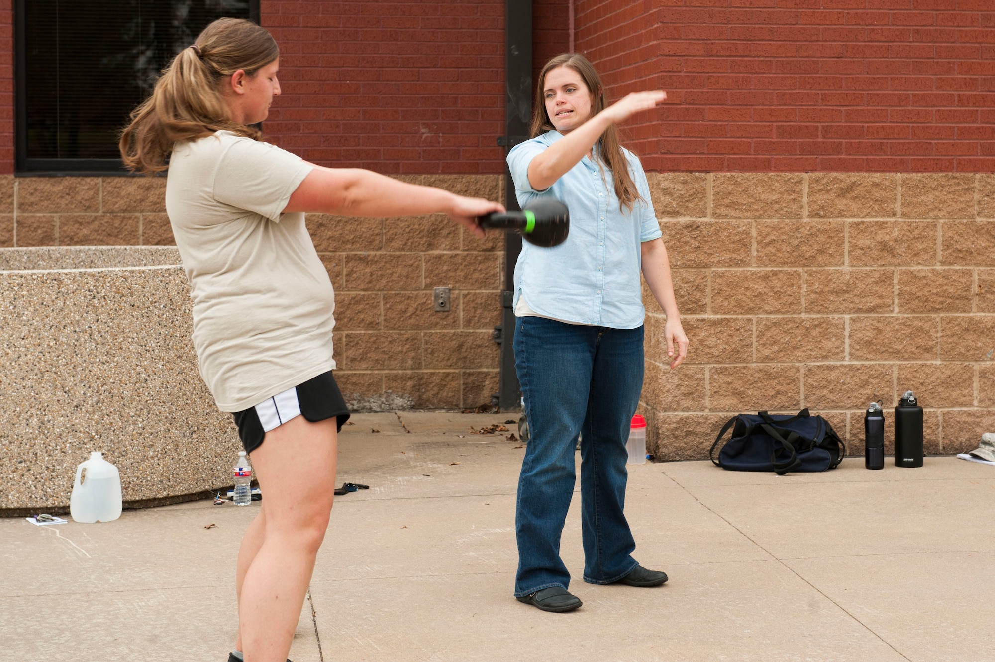 From right, Jill Hinsley, 19th Aerospace Medicine Squadron registered dietician, teaches U.S. Air Force Staff Sgt.  Kendra Mcalpin, 19th Logistic Readiness Squadron aircraft part store supervisor, proper techniques for kettlebell swings Nov. 4, 2015, at Little Rock Air Force Base, Ark. Vital 90 is geared toward helping Airmen stay Fit-to-Fight. (U.S. Air Force photo by Senior Airman Stephanie Serrano)