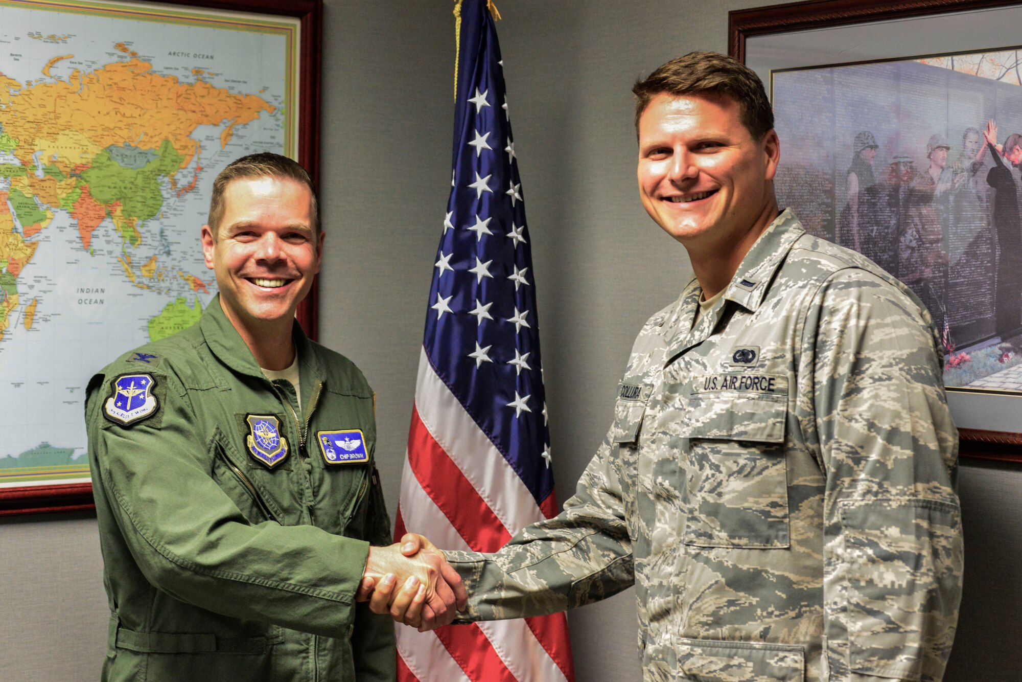 From right, U.S. Air Force 1st Lt. Joseph Collura, 19th Mission Support Group executive officer, is congratulated by U.S. Air Force Col. Charles Brown Jr., 19th Airlift Wing commander, as Combat Airlifter of the Week Oct. 26, 2015, for Little Rock Air Force Base. Collura is the primary point of contact for the 19th MSG Golf Fundraiser, raising more than $6,000 in the last two years. (U.S. Air Force photo by Tech. Sgt. Jason Armstrong)  