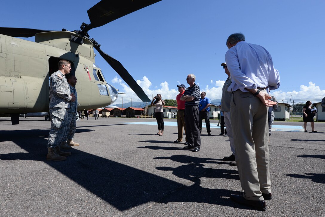 U.S. Army Chief Warrant Officer Daniel Keslar, 1-228 Aviation Regiment pilot, and Sgt. Matthew Teleha, 1-228 AR flight engineer, talk to members of Congress on Soto Cano Air Base, Honduras, Nov. 1,2015, informing them of the mission capabilities of the CH-47 Chinook helicopter and UH-60 Blackhawk helicopter (not pictured), and their operations in the Central American area of responsibility. The Congressional members visited Soto Cano and U.S. Embassies in Honduras and Guatemala during their visit to the Central American region. (U.S. Air Force photo by Senior Airman Westin Warburton/Released)