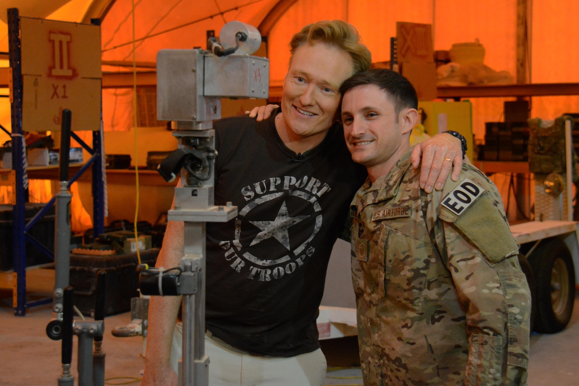 Late night talk show host and comedian, Conan O’Brien, poses for a photo with Master Sgt. Bradley Kline, 379th Expeditionary Civil Engineer Squadron Explosive Ordnance Disposal Flight section chief, during a visit to Al Udeid Air Base, Qatar Nov. 4. During his visit, O'Brien put on a variety show for deployed service members and thanked them for all they do to defend America. (U.S. Air Force photo by Tech. Sgt. James Hodgman)
