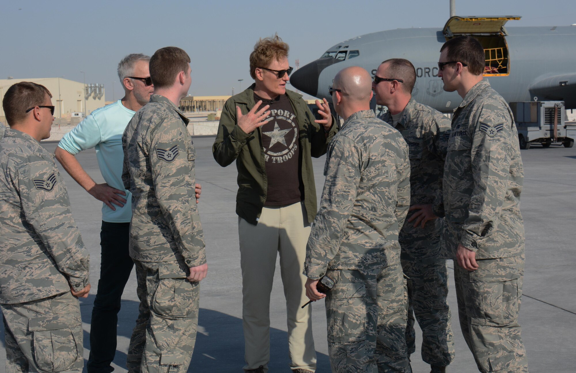 Late night talk show host and comedian, Conan O’Brien, visits with Airmen deployed to Al Udeid Air Base, Qatar on the flightline during a base visit Nov. 4. O’Brien visited AUAB to entertain service members. He said he was honored to perform for America’s warriors and thanked all service members for what they do to defend America’s freedom. (U.S. Air Force photo by Tech. Sgt. James Hodgman)