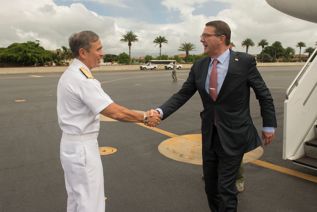 Defense Secretary Ash Carter, right, shakes hands with Navy Adm. Harry B. Harris Jr., commander of U.S. Pacific Command, as he arrives in Hawaii, Nov. 5, 2015. DoD photo by Air Force Senior Master Sgt. Adrian Cadiz