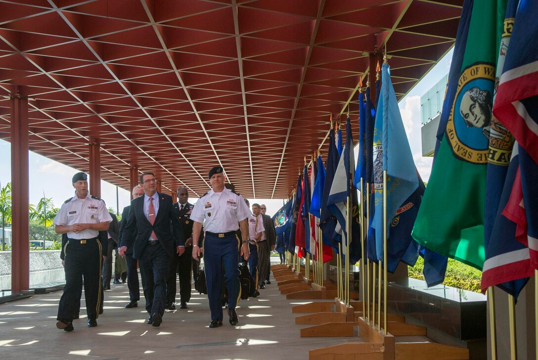 Defense Secretary Ash Carter, center, walks with Army Brig. Gen. Mark Spindler, deputy director of the Defense POW/MIA Accounting Agency, and Army Sgt. Maj. Michael E. Swam, the agency's senior enlisted leader, as he arrives on Joint Base Pearl Harbor–Hickam, Honolulu, Nov. 5, 2015. DoD photo by Air Force Senior Master Sgt. Adrian Cadiz