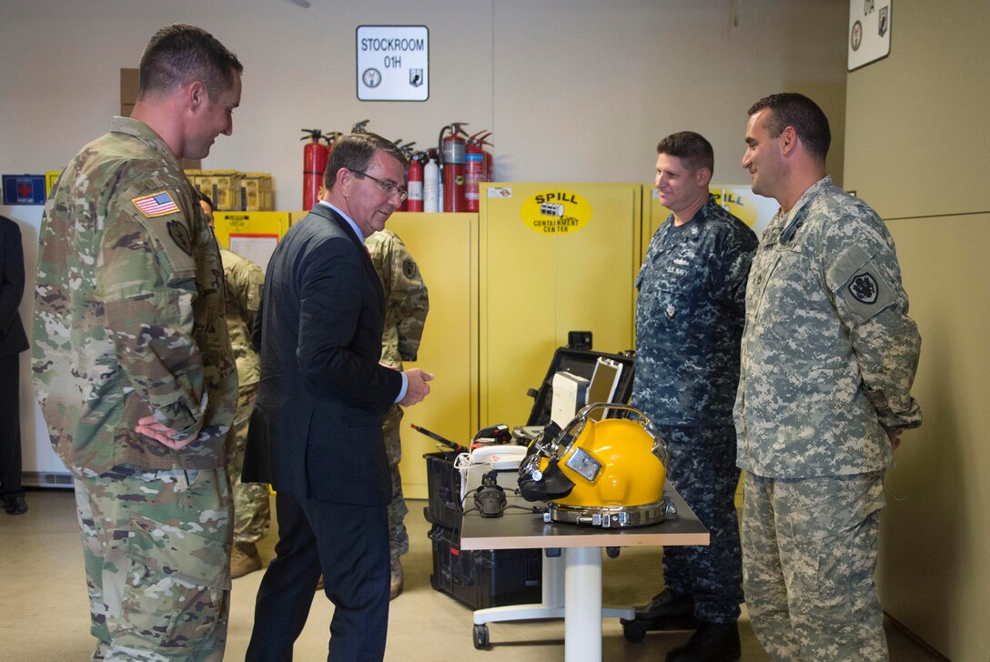 Defense Secretary Ash Carter, left, speaks with members of the recovery team from the Defense POW/MIA Accounting Agency and views some of the equipment they use as he tours the facility on Joint Base Pearl Harbor–Hickam, Honolulu, Nov. 5, 2015. DoD photo by Senior Master Sgt. Adrian Cadiz