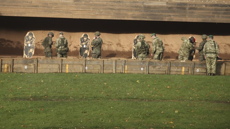 U.S. Marines with 2nd Intelligence Battalion and British soldiers shoot during a combat marksmanship range near Edinburgh, U.K., Oct. 30, 2015. The service members are currently executing Exercise Phoenix Odyssey II, which is designed to build joint intelligence operational abilities while also enhancing military skills. 