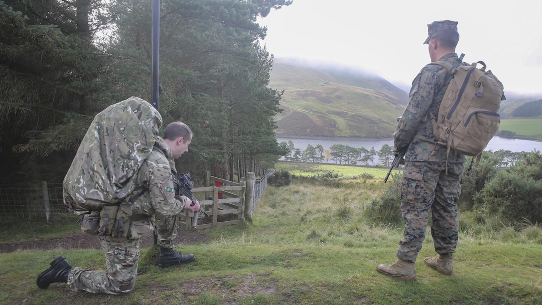A British soldier, left, and U.S. Marine Lance Cpl. Jason Schillingburg, right, an intelligence specialist with 2nd Intelligence Battalion, rest after finding a checkpoint on a three-mile conditioning hike during Exercise Phoenix Odyssey II near Edinburgh, U.K., Oct. 30, 2015. The exercise is built to strengthen intelligence capabilities in a joint setting, while also bolstering military skills such as land navigation and combat marksmanship in preparation for potential real-world contingencies. 