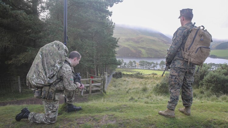 A British soldier, left, and U.S. Marine Lance Cpl. Jason Schillingburg, right, an intelligence specialist with 2nd Intelligence Battalion, rest after finding a checkpoint on a three-mile conditioning hike during Exercise Phoenix Odyssey II near Edinburgh, U.K., Oct. 30, 2015. The exercise is built to strengthen intelligence capabilities in a joint setting, while also bolstering military skills such as land navigation and combat marksmanship in preparation for potential real-world contingencies. 