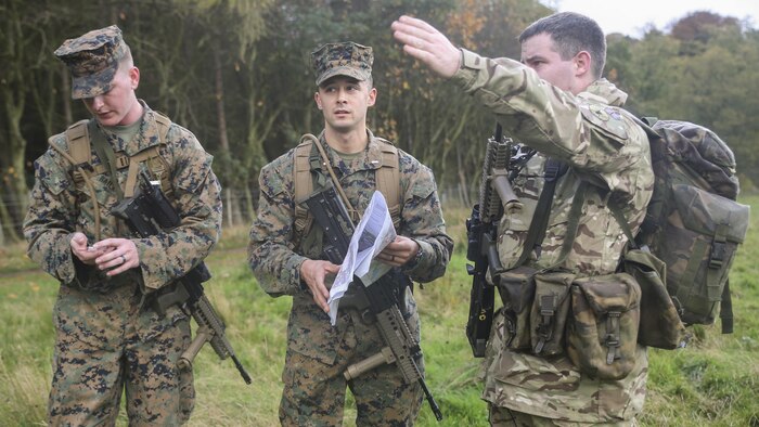 U.S. Marine Sgt. Kyle Bailey, left, and 1st Lt. Conn Wiseman, center, discuss possible routes with a British soldier while trying to complete a three-mile conditioning hike during Exercise Phoenix Odyssey II near Edinburgh, U.K., Oct. 30, 2015. Bailey is an intelligence specialist, and Wiseman is an air intelligence officer, both with 2nd Intelligence Battalion. The exercise is designed to enhance joint intelligence operations, while also building military skills in preparation for potential real-world crises. 