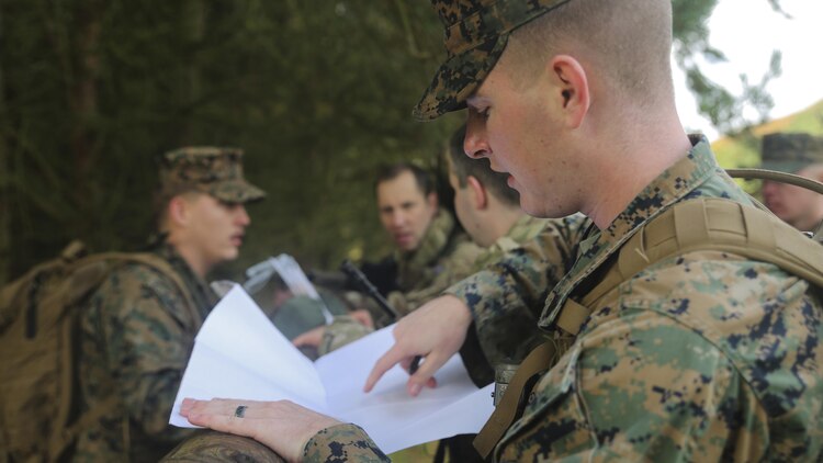 U.S. Marine Sgt. Kyle Bailey, an intelligence specialist with 2nd Intelligence Battalion, checks coordinates while searching for a checkpoint during Exercise Phoenix Odyssey II near Edinburgh, U.K., Oct. 30, 2015. The Marines are partnering with British soldiers to enhance joint intelligence operations, and worked to build military skills such as land navigation and combat marksmanship. 